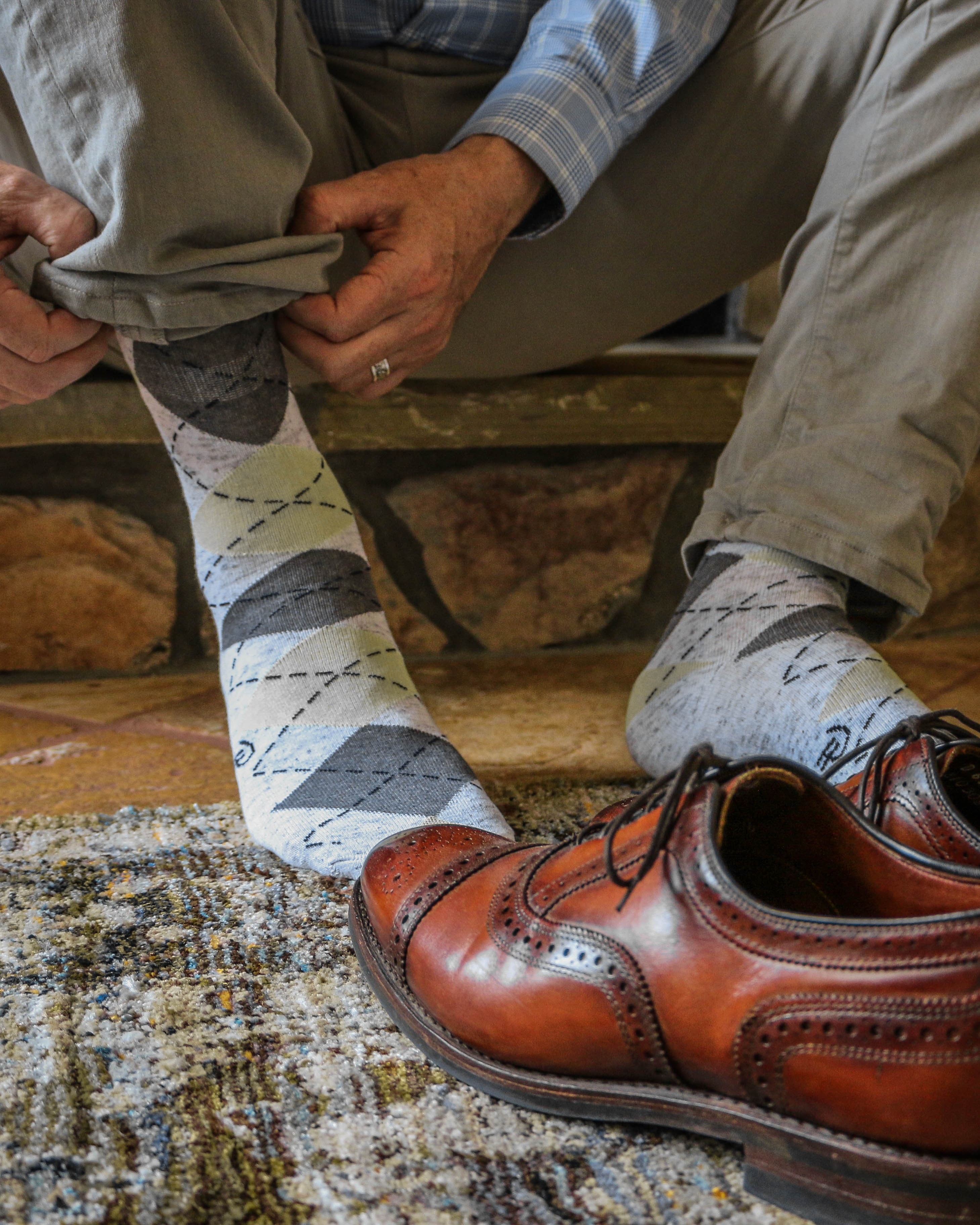 light grey and brown argyle over the calf dress socks, brown dress shoes, casual light brown pants, blue plaid dress shirt