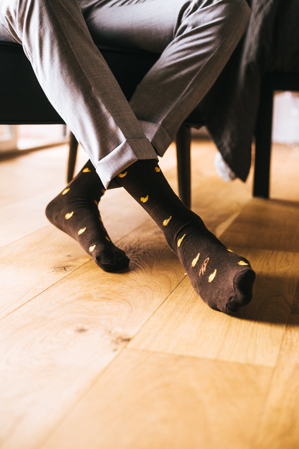 black over the calf dress socks with yellow duck prints, grey dress pants