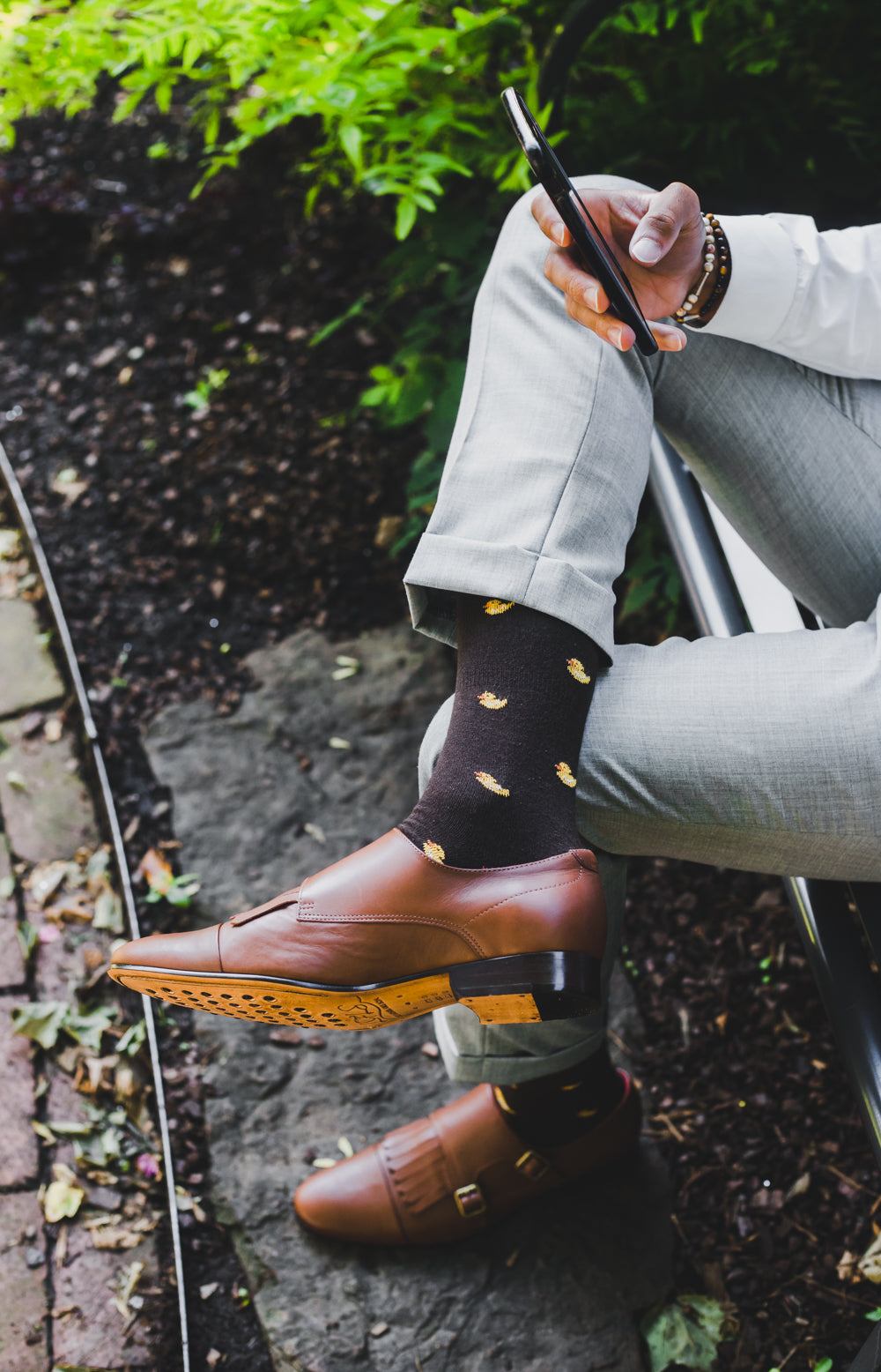 black over the calf dress socks with yellow duck prints, light brown dress shoes, grey dress pants