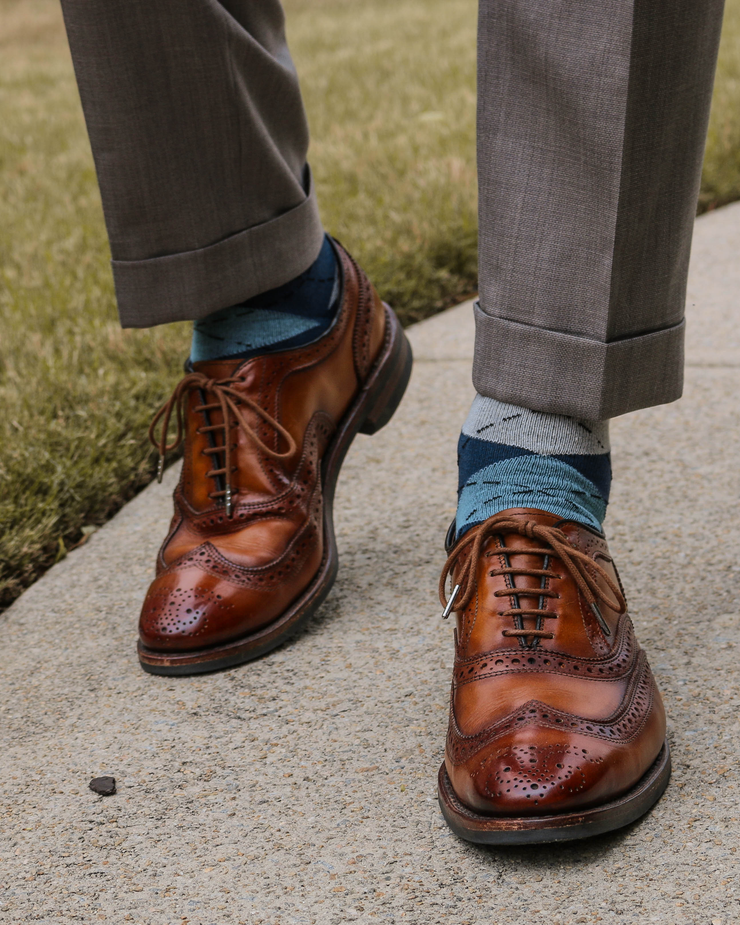 blue grey and navy blue argyle over the calf dress socks, brown dress shoes, grey dress pants