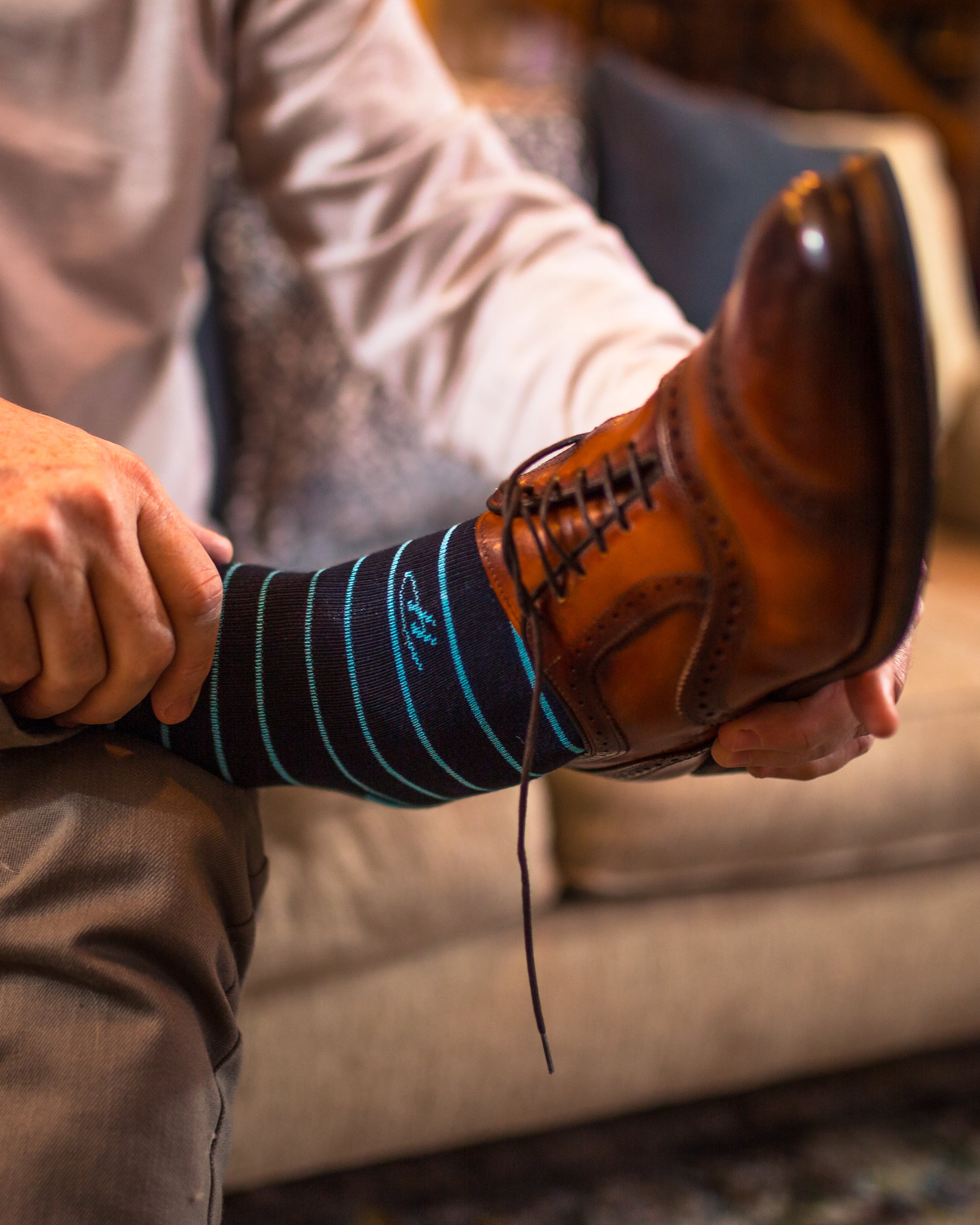 black over the calf dress socks with light blue stripes, brown dress socks, and a shirt