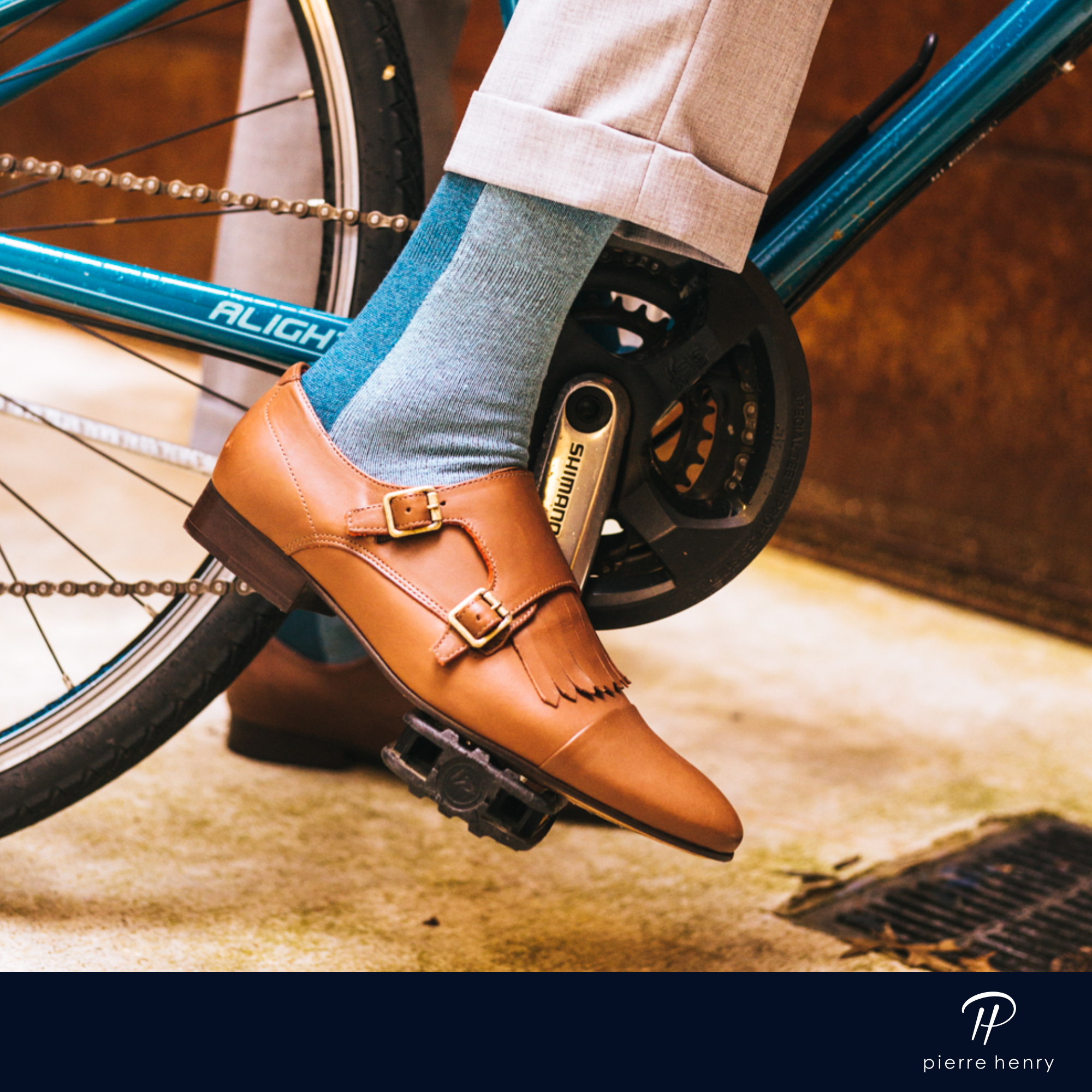 light blue over the calf dress socks with blue stripe, light brown dress shoes, grey dress pants, a blue bike