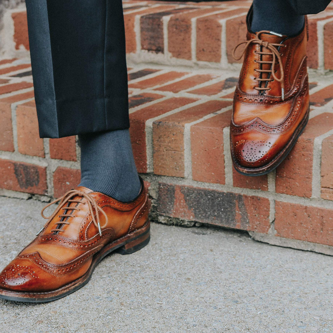 solid light grey over the calf dress socks, light brown dress shoes, and black dress pants