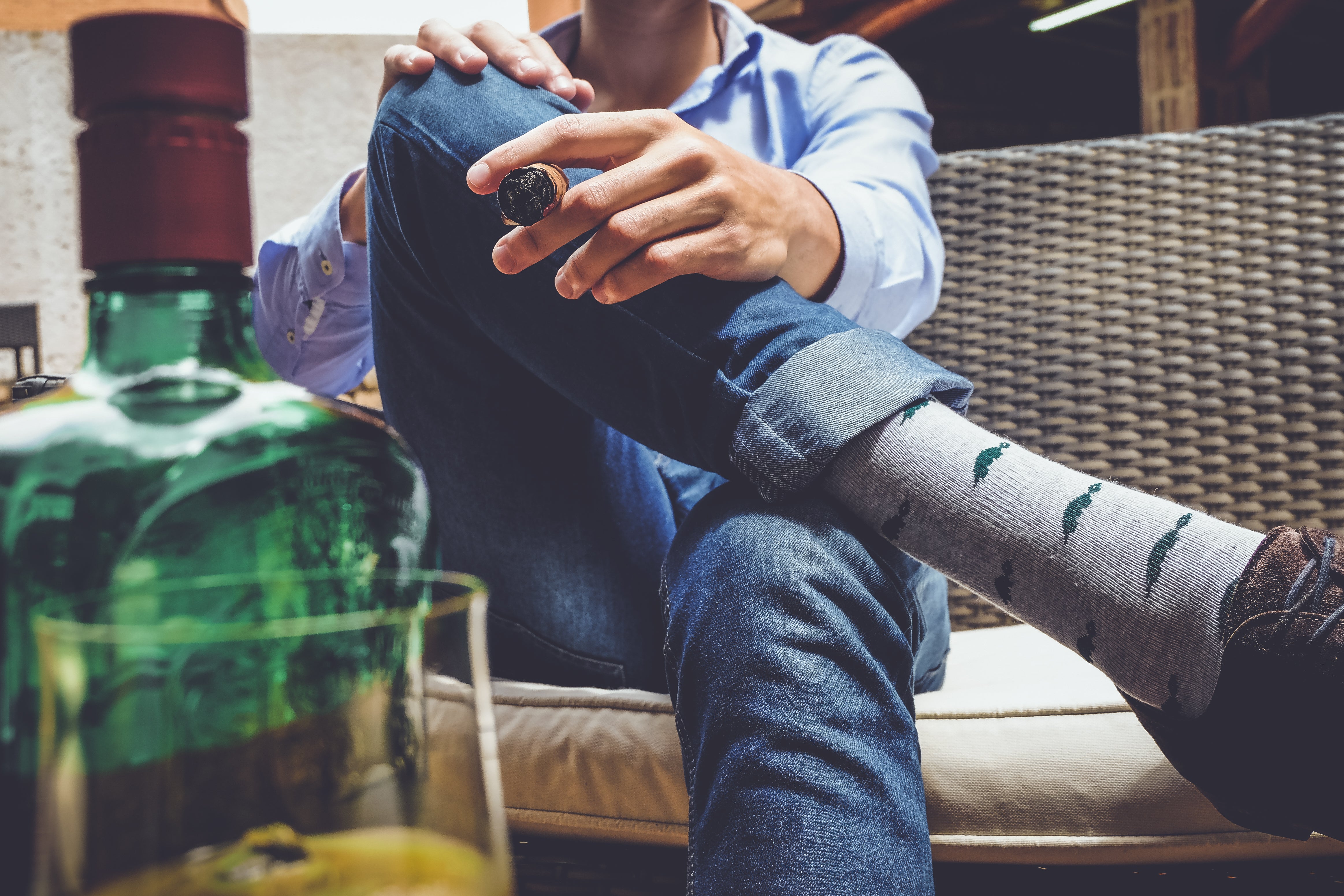 light grey over the calf dress socks with dark green turtles, leather brown dress shoe, blue jeans, cigar on hand