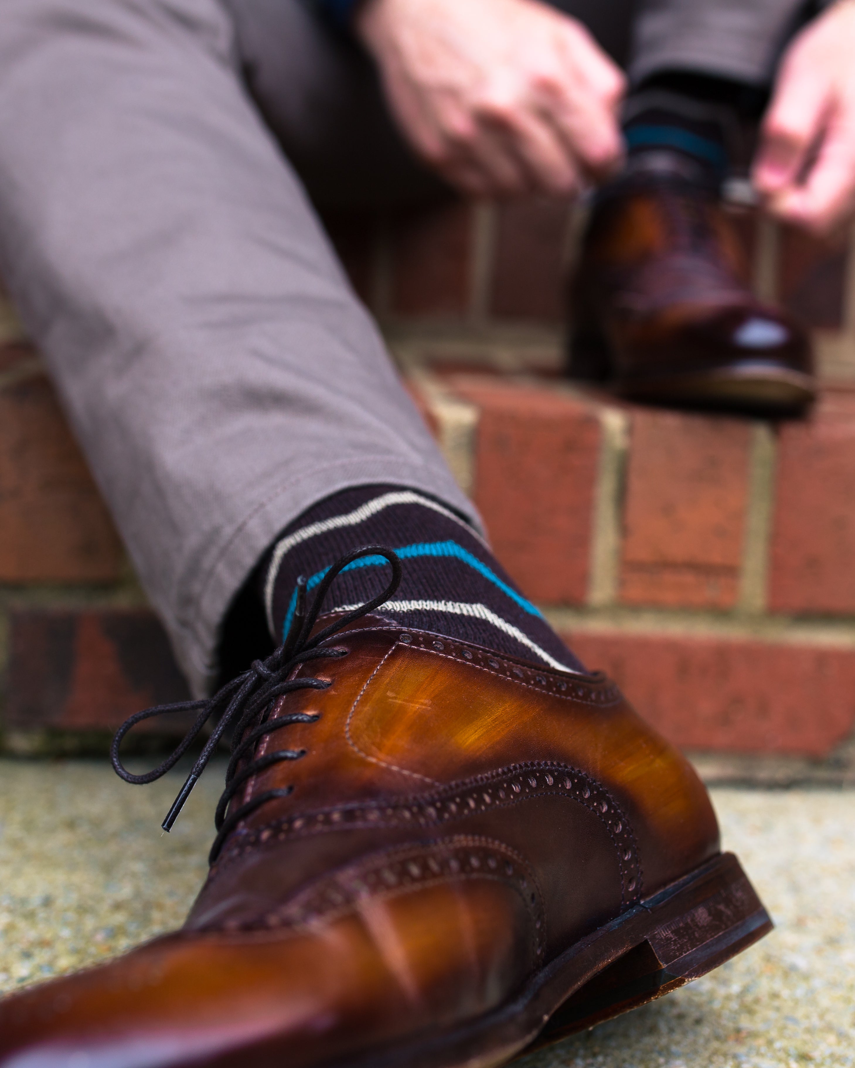 purple over the calf dress socks with blue and white stripes, brown dress shoes, grey dress pants