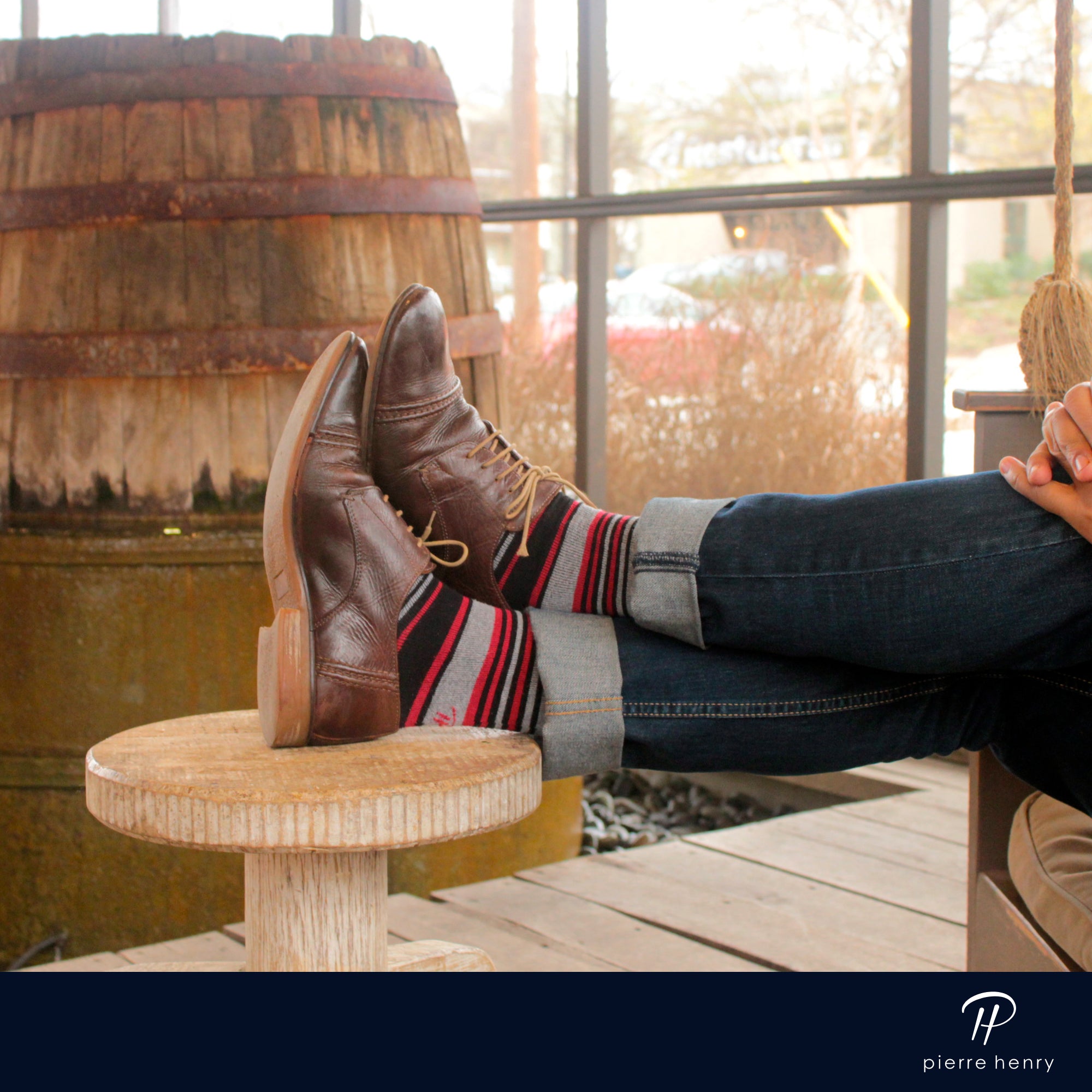 black red and light grey striped over the calf dress socks, brown dress shoes, blue jeans