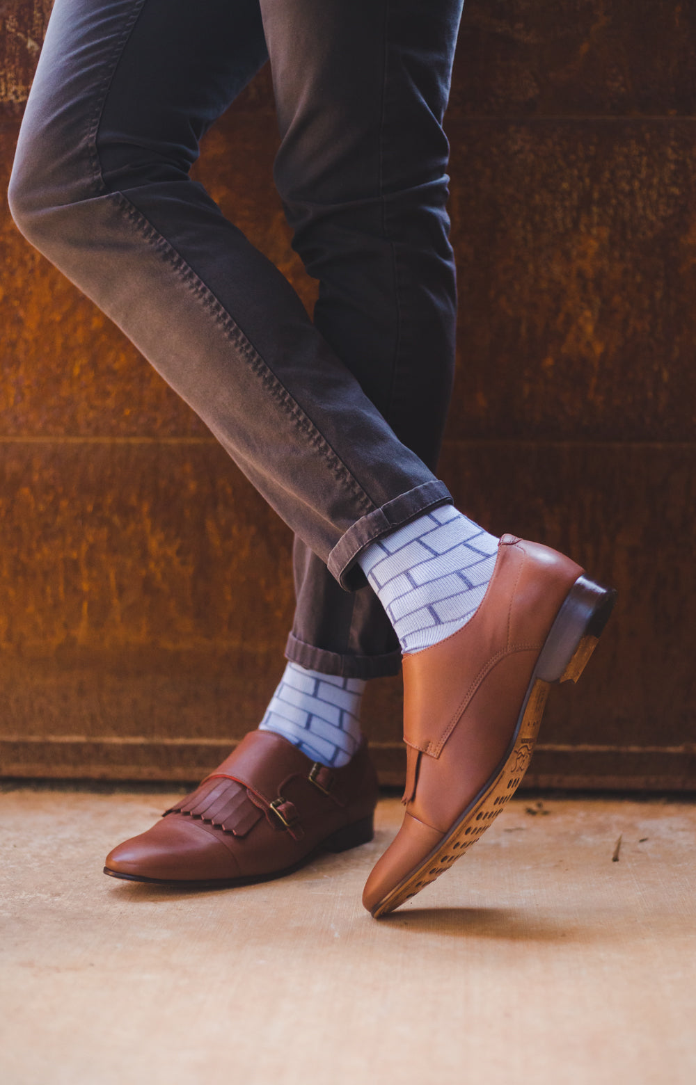 light blue over the calf dress socks with blue brick line pattern, brown dress shoes, dark brown pants