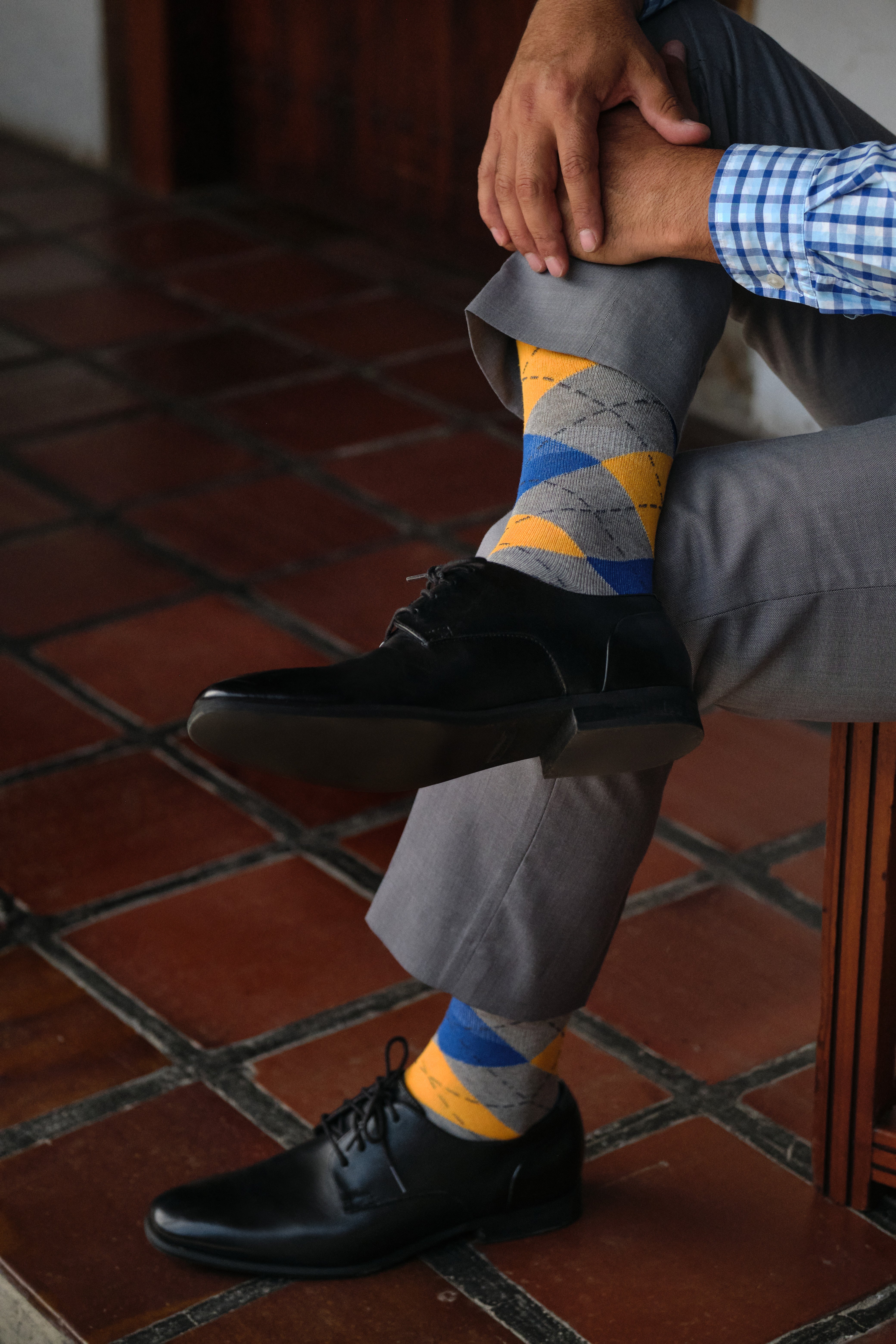 argyle grey blue and orange mid calf dress socks, black dress shoes, grey dress pants