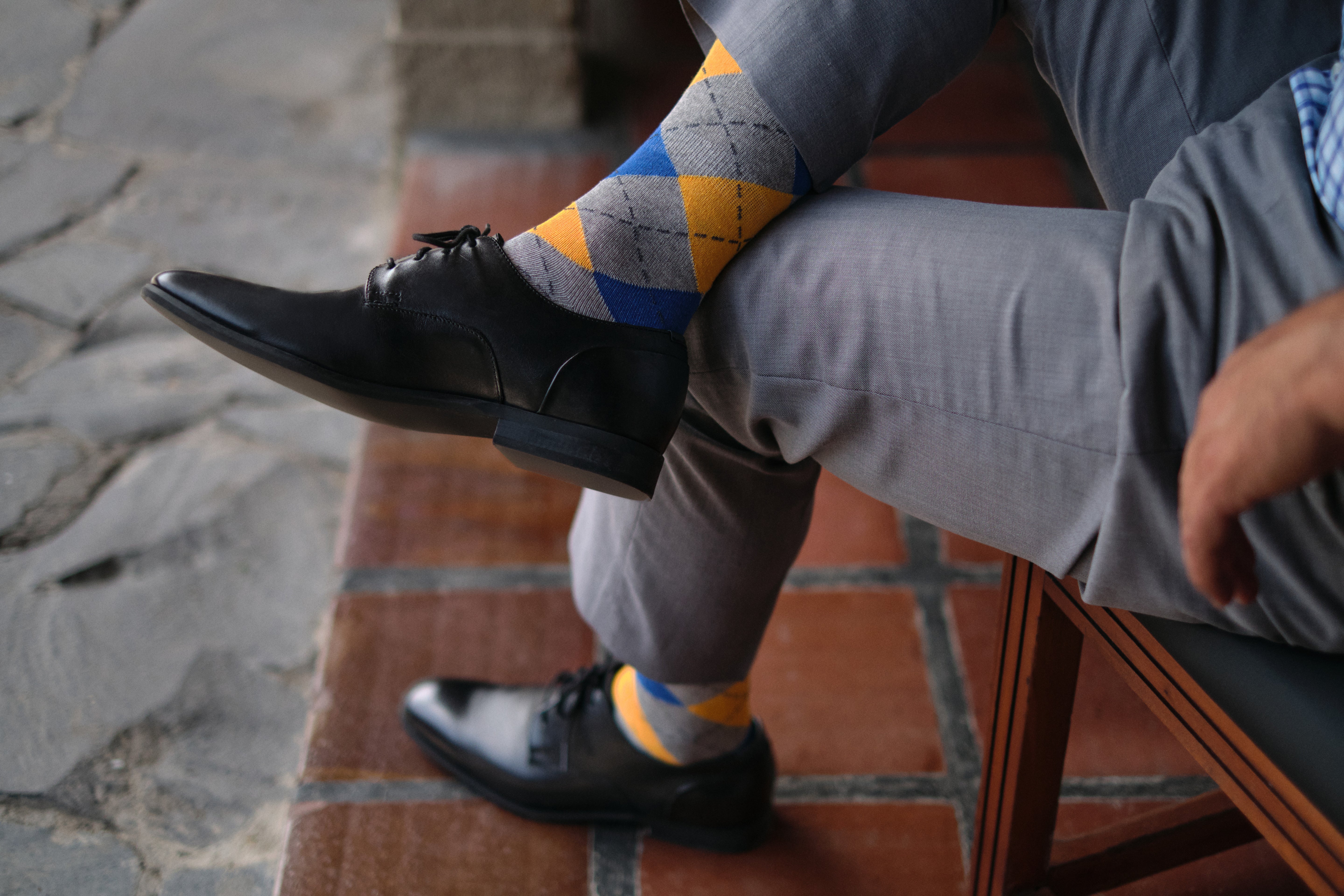 argyle grey blue and orange mid calf dress socks, black dress shoes, grey dress pants