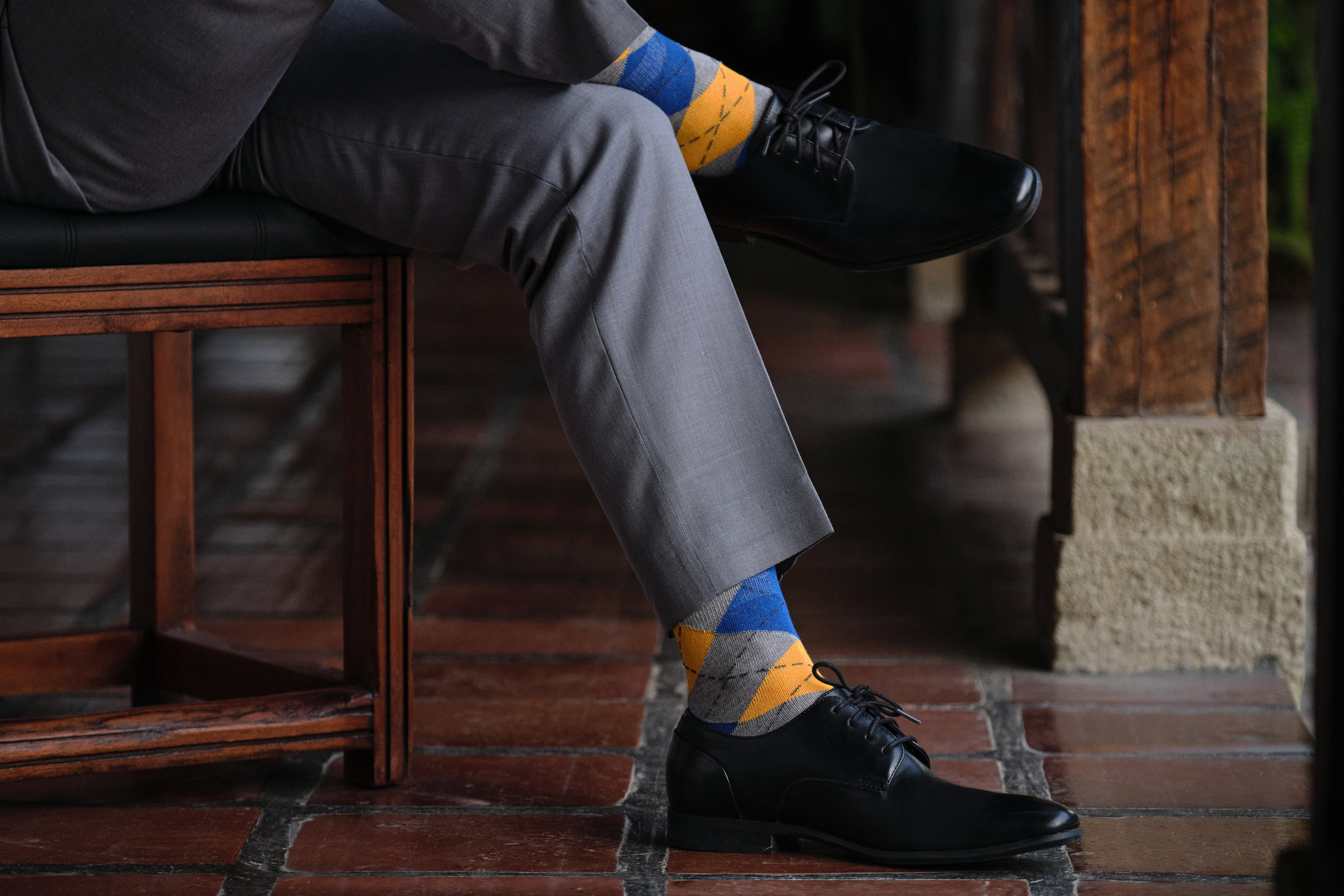 argyle grey blue and orange mid calf dress socks, black dress shoes, grey dress pants