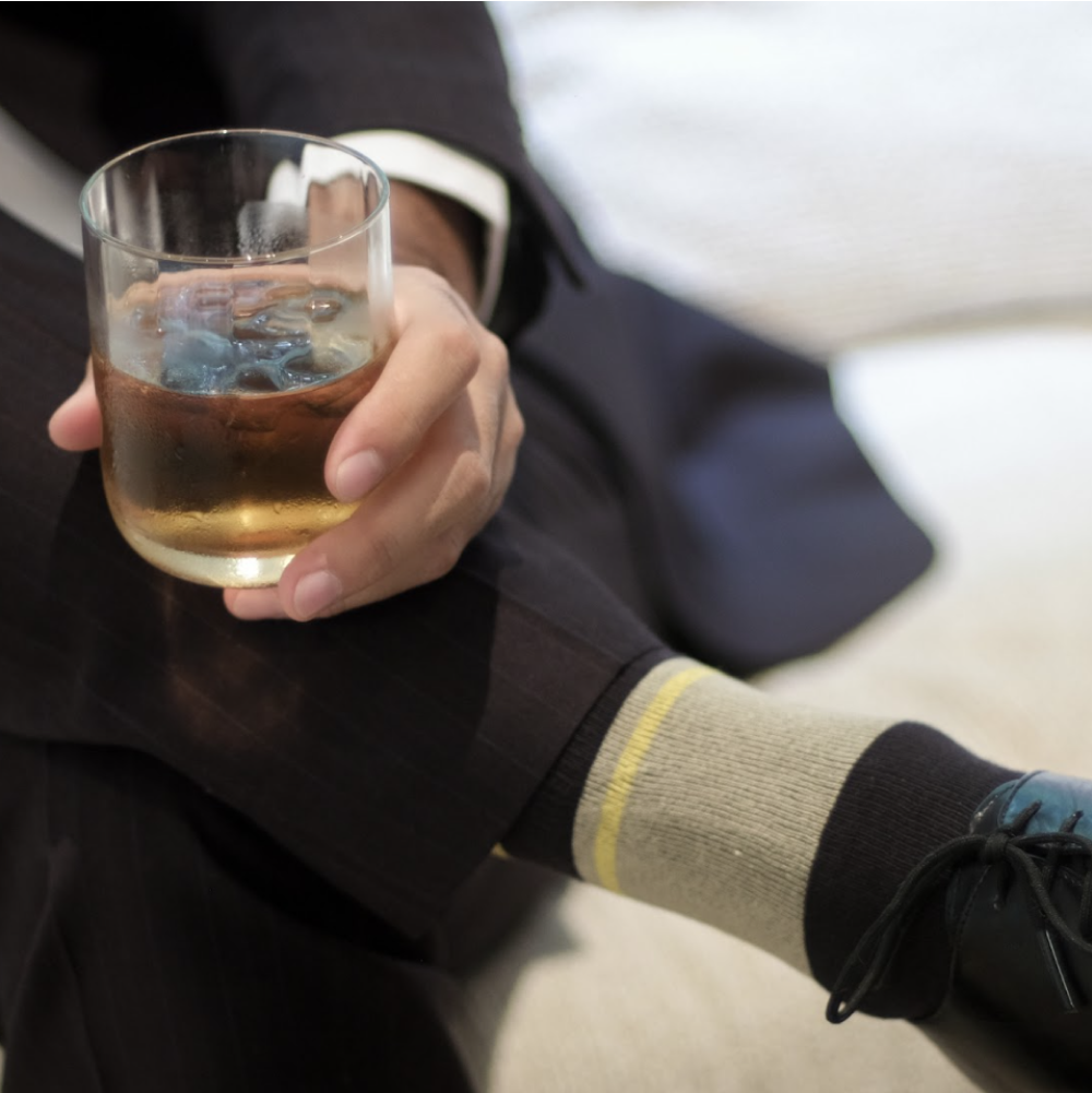 beige and black over the calf dress socks with small yellow stripe on calf