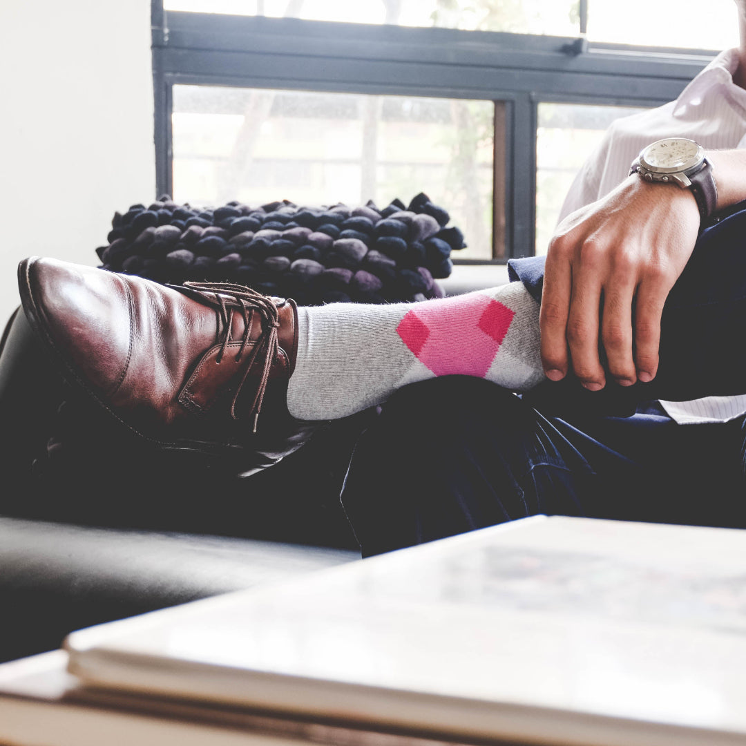 Gray and pink socks with brown shoes 