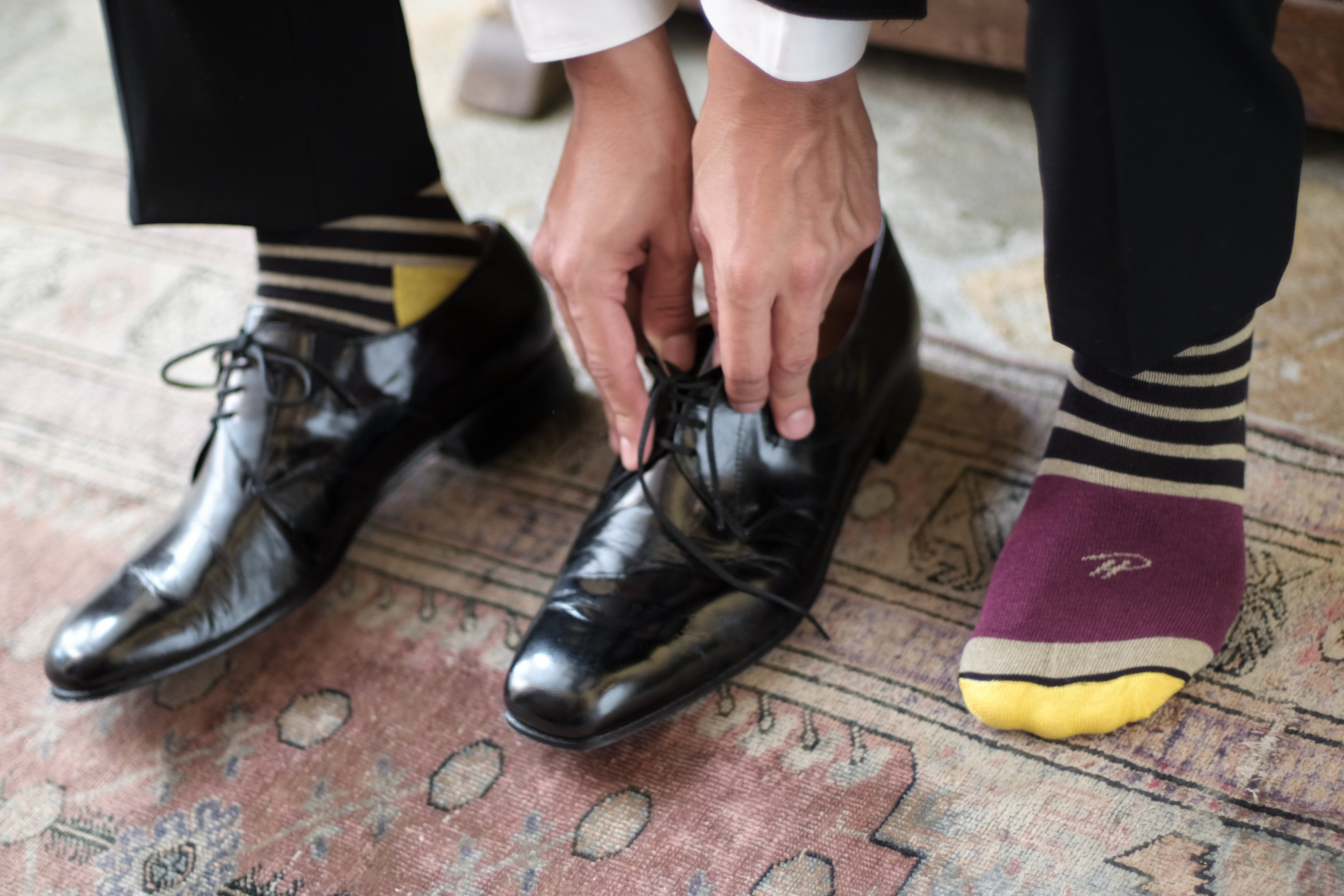 beige and black striped over the calf dress socks with plum foot and yellow toe, black dress shoes, black dress pants