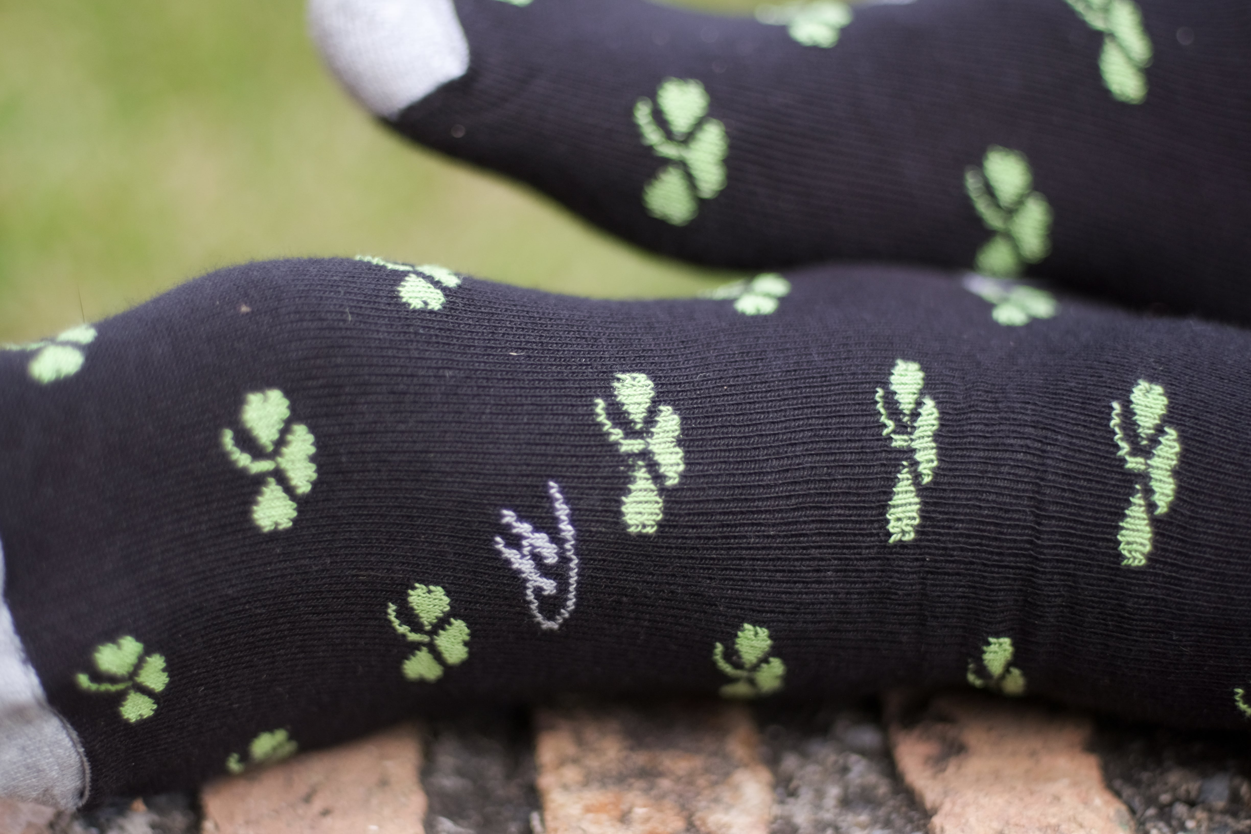 Black over the calf dress socks with green clover pattern