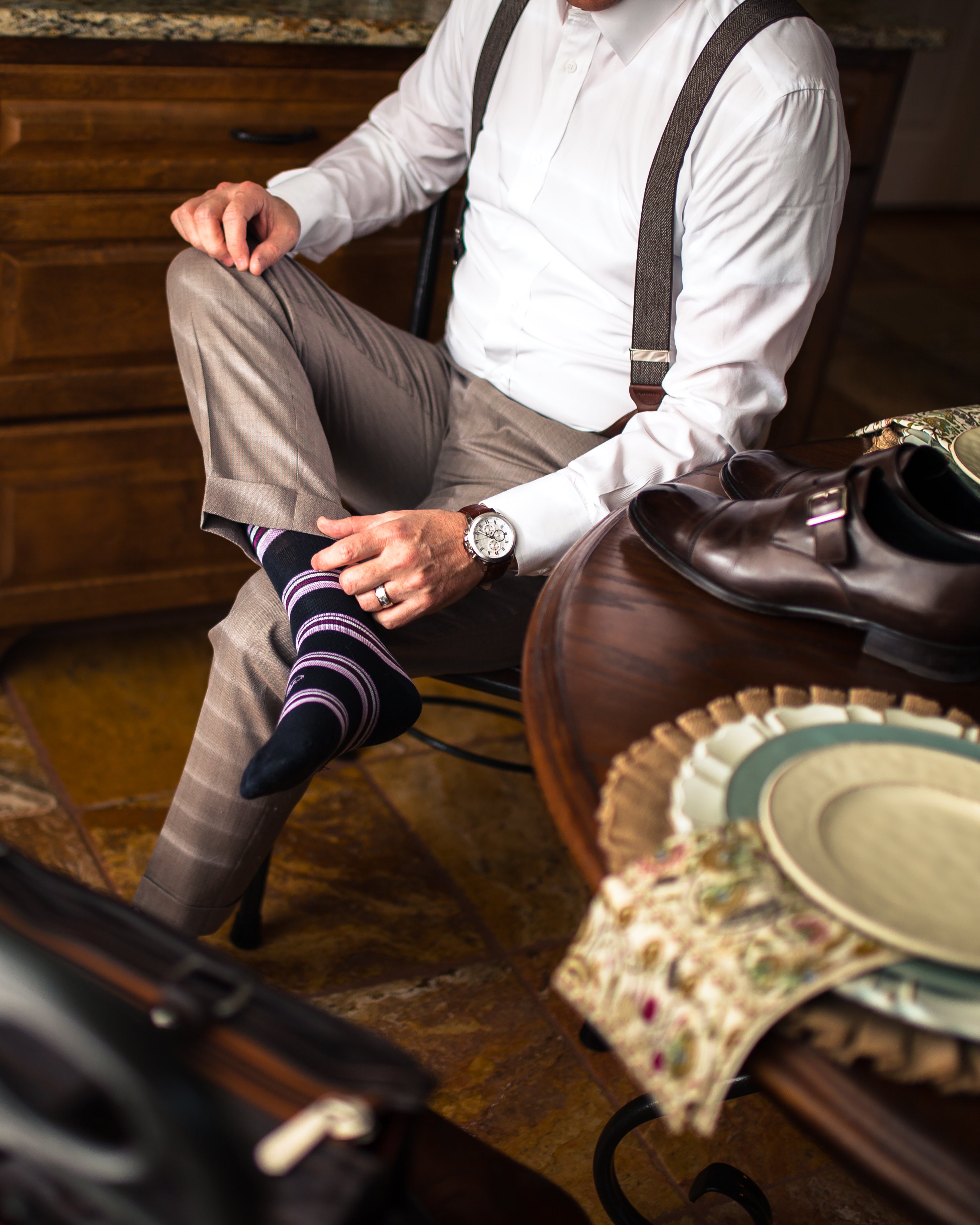 black over the calf dress socks with purple and light pink stripes, beige dress pants, brown watch, white dress shirt