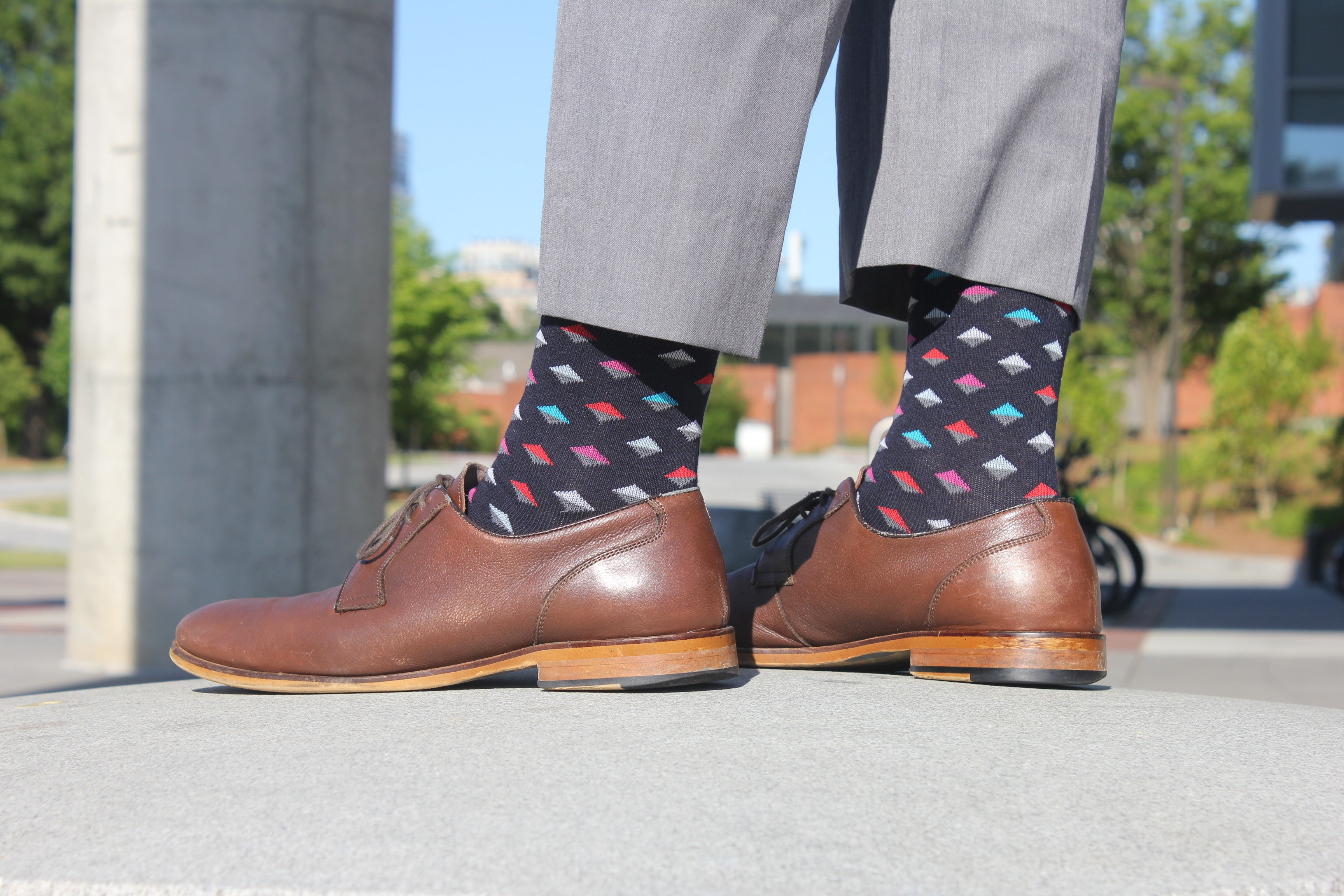 black over the calf dress socks with colored diamond pattern, brown dress shoes, light grey dress pants