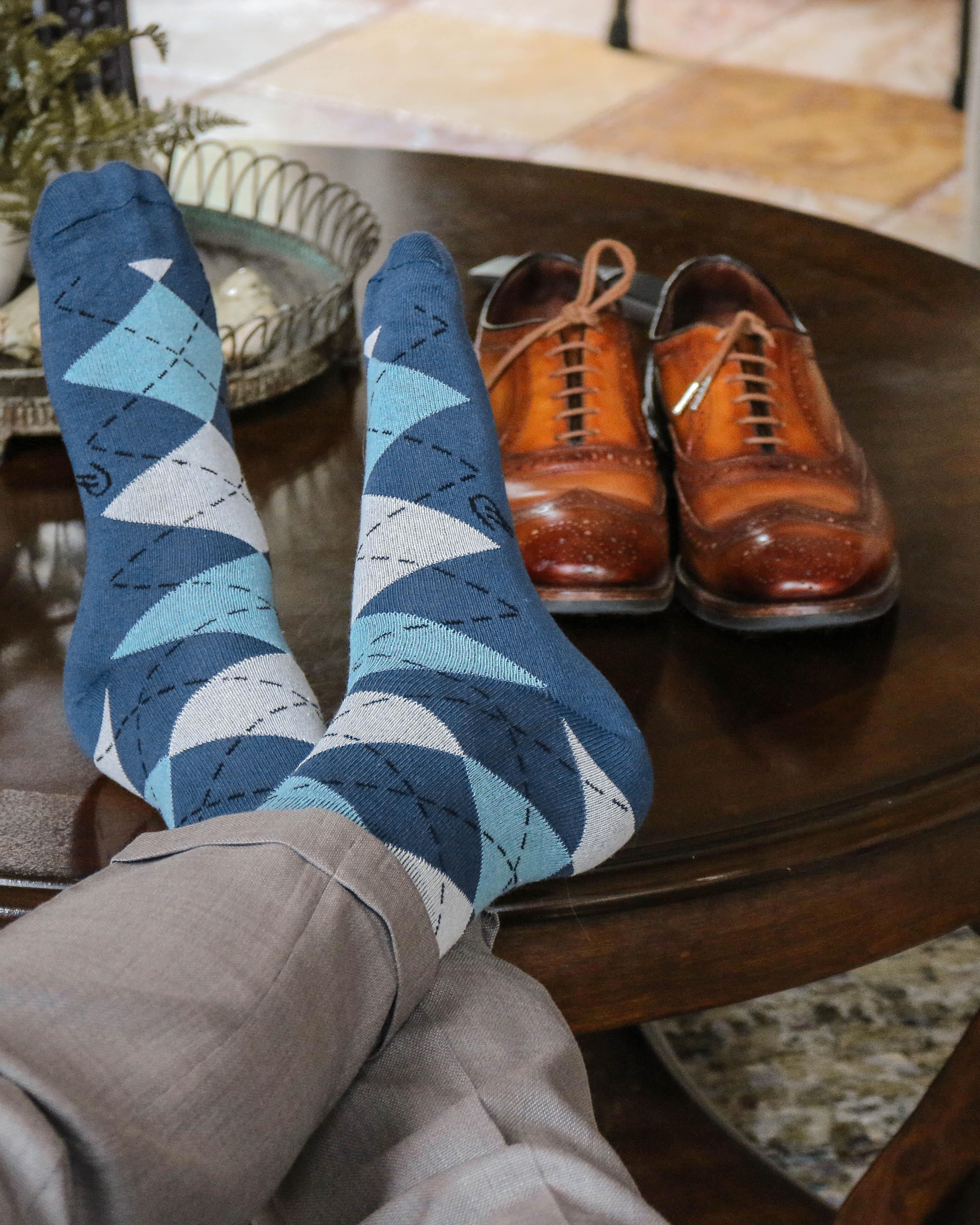 blue and white argyle print over the calf dress socks, brown dress shoes, grey dress pants