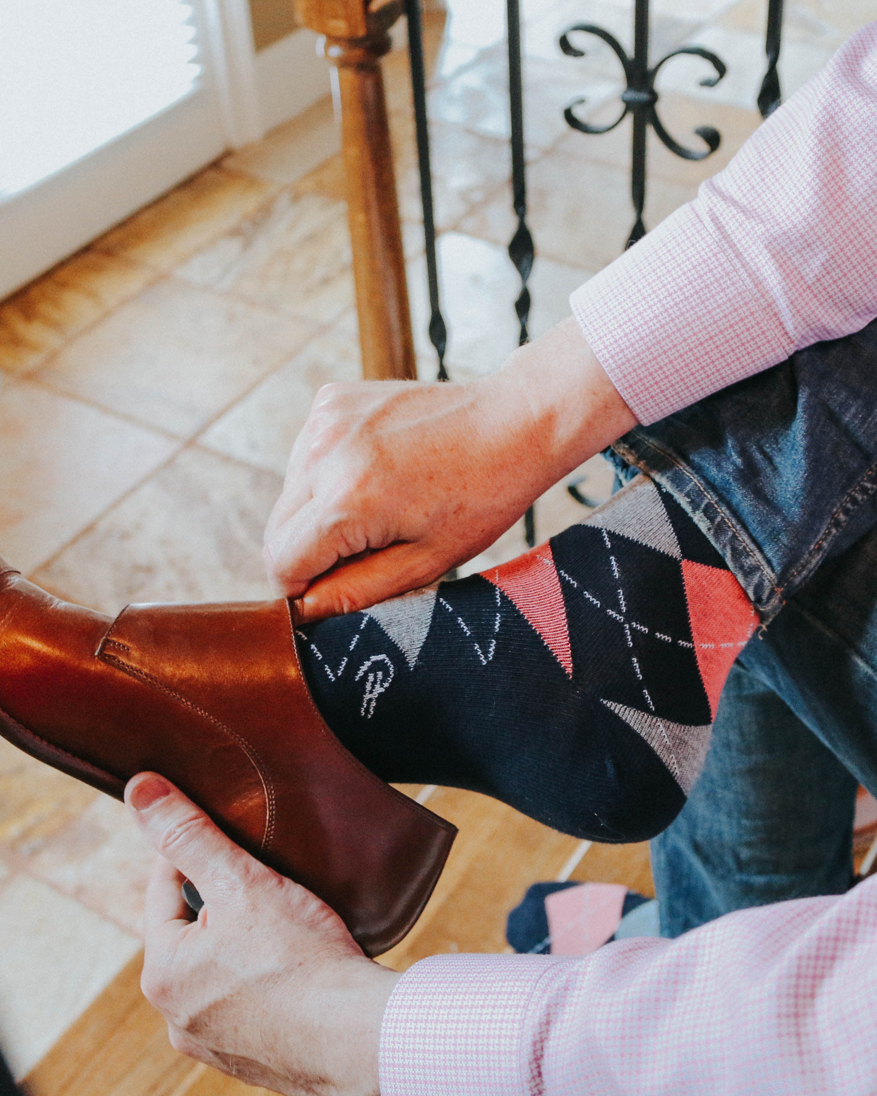 blue pink and grey argyle print over the calf dress socks, brown dress shoes, blue jeans