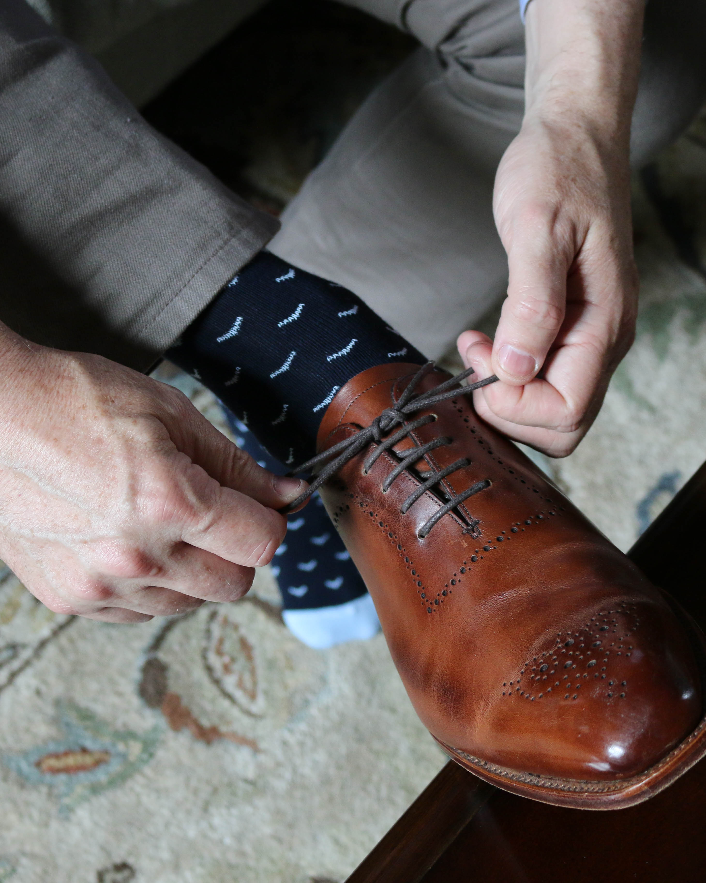 navy blue over the calf dress socks with light blue print, brown dress shoes with grey laces, grey casual pants