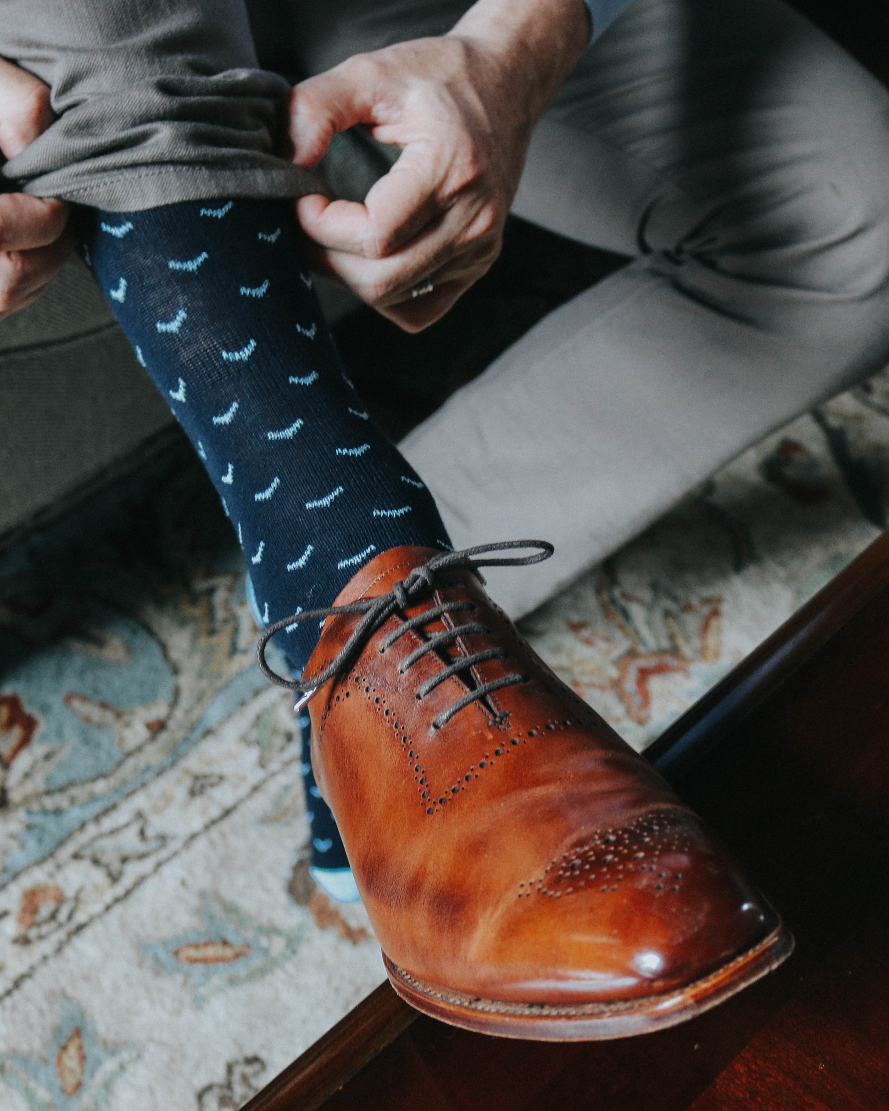 blue over the calf dress socks with light blue print, brown dress shoe with grey laces, grey dress pants