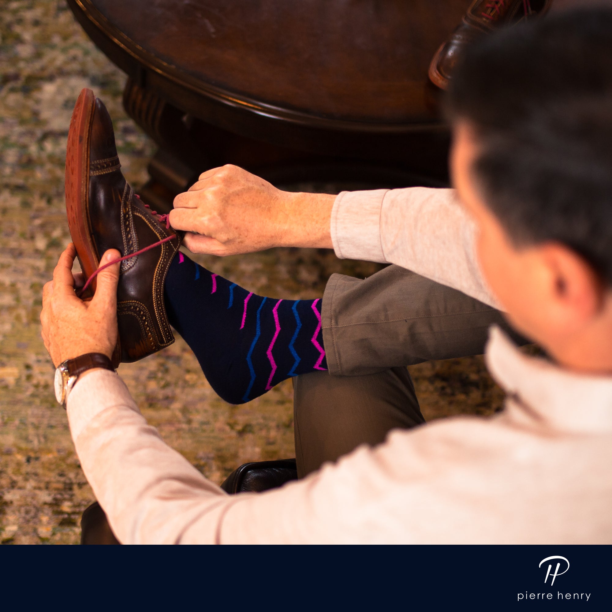 navy blue over the calf dress socks with blue and pink zigzag lines, brown dress shoes with pink laces, brown watch, brown pants