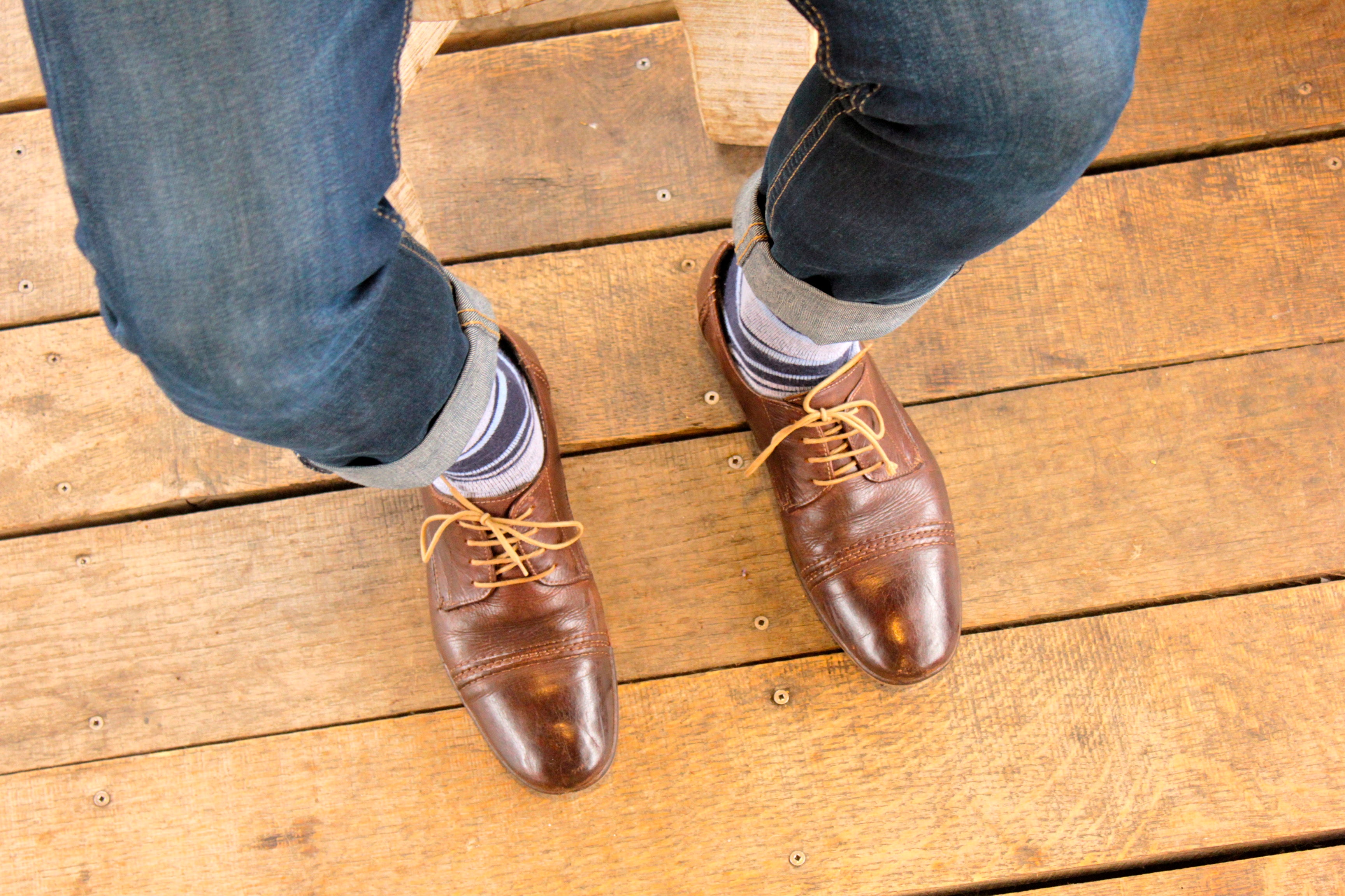 blue and grey striped over the calf dress socks, brown dress shoes, and blue jeans