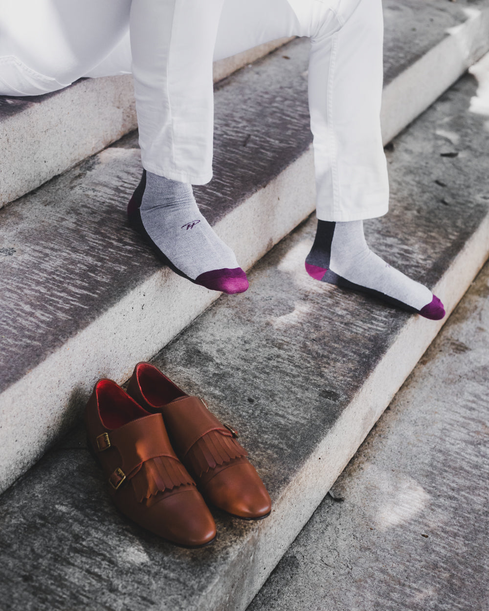 light grey over the calf dress socks with purple toe and heel and black stripe, brown shoes, on a staircase