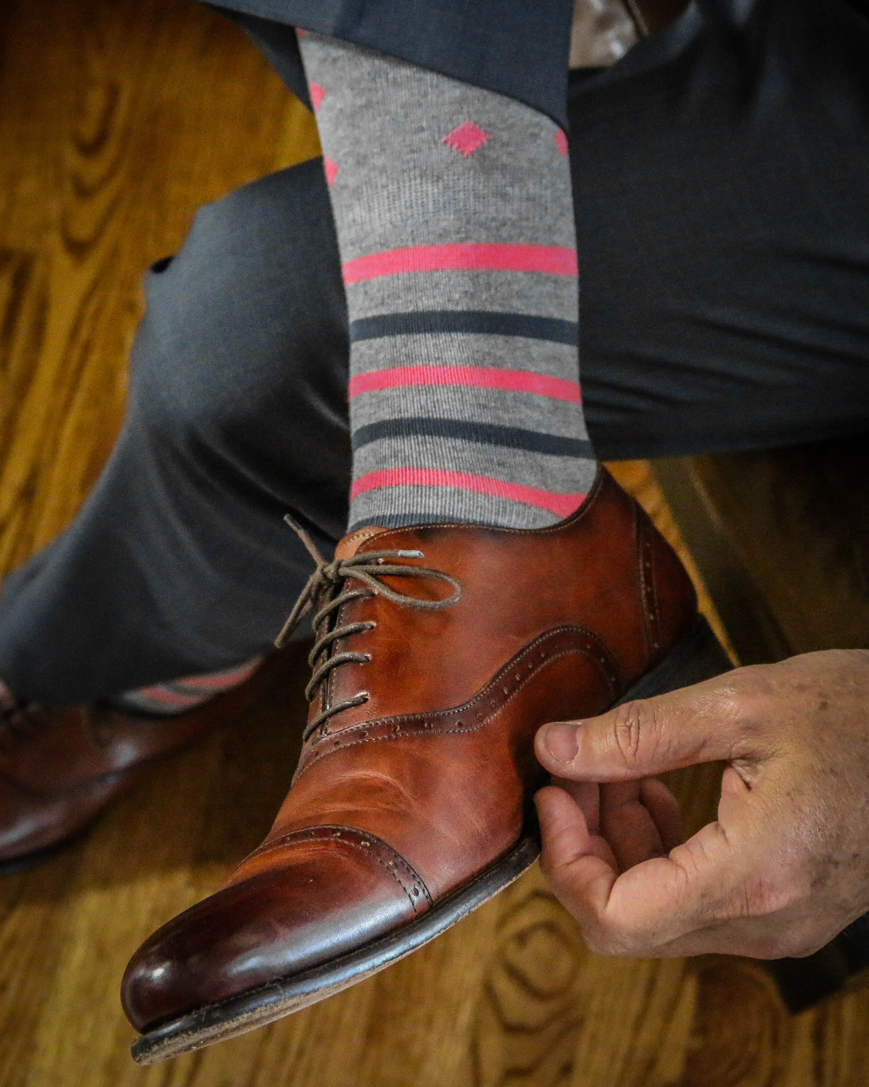 light grey over the calf dress socks with grey and pink stripes and pink diamond prints, brown dress shoes, grey dress pants