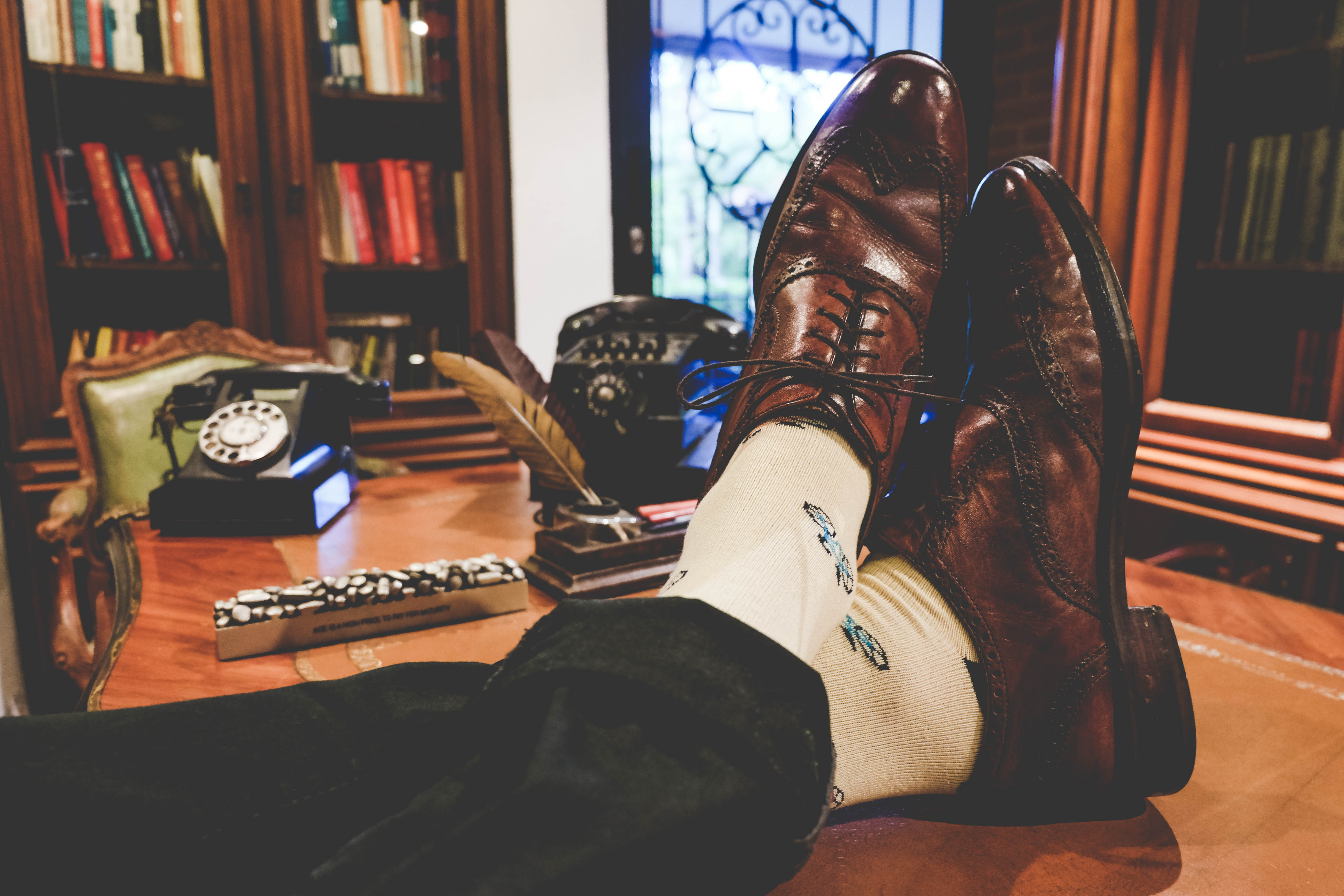 beige over the calf dress socks with cycle pattern, brown dress shoes, black pants