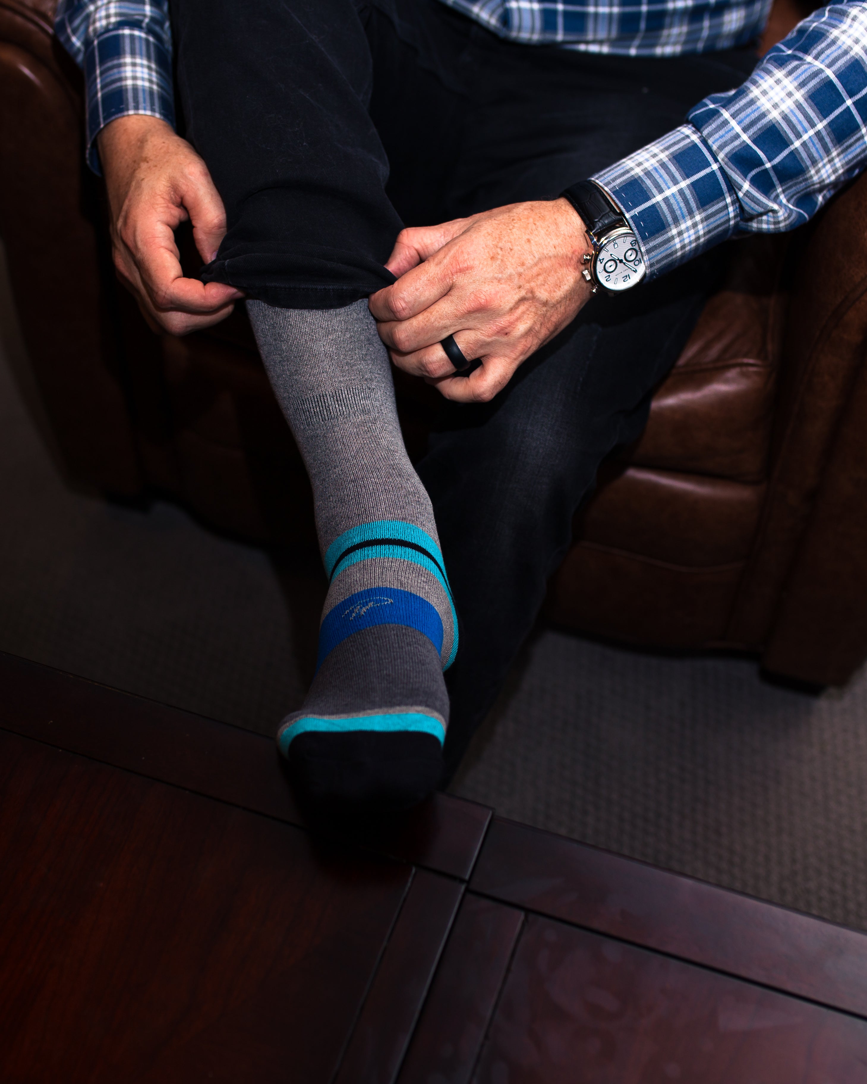 grey over the calf dress socks with light blue and blue stripes, black jeans, black watch