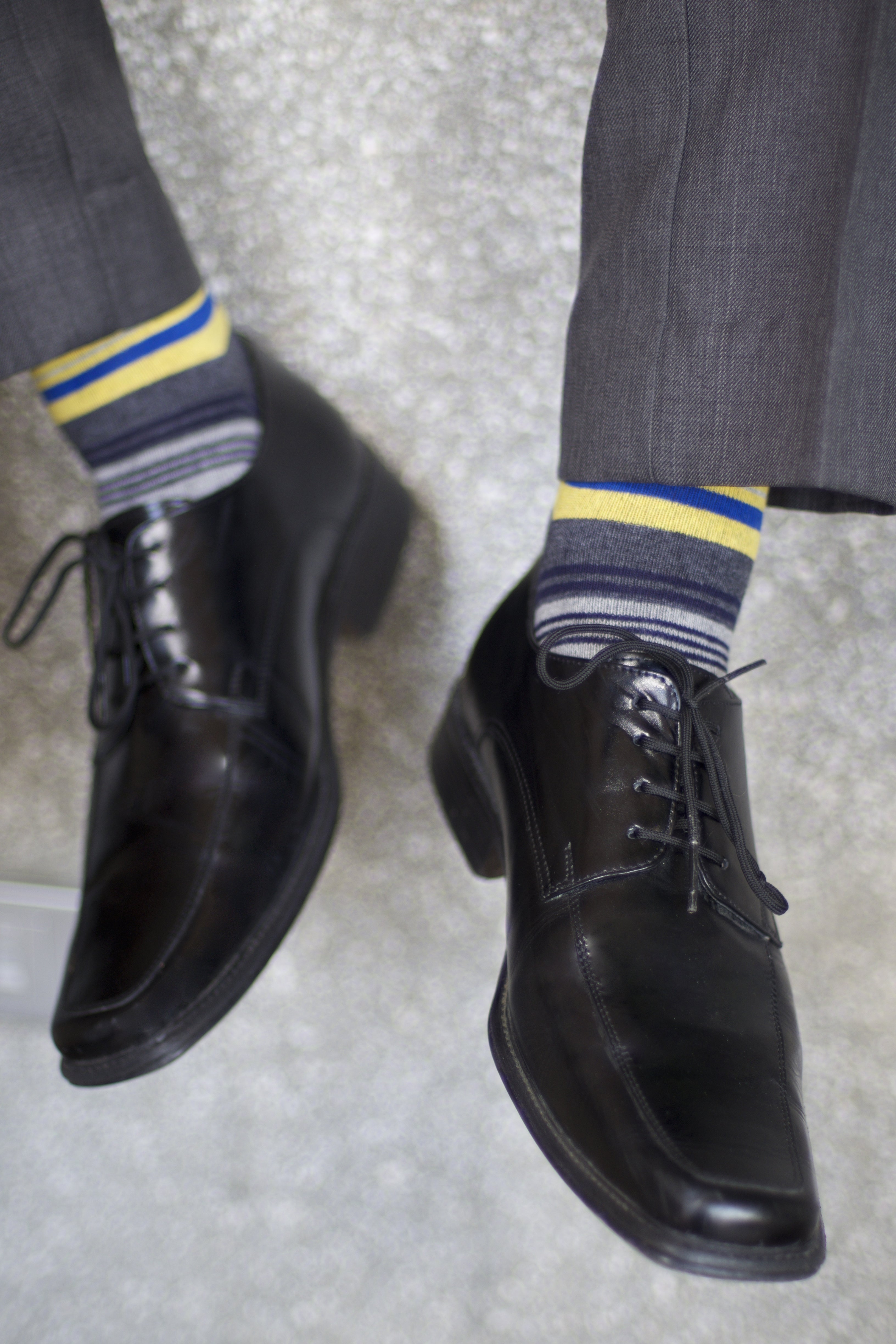 light grey blue grey and yellow striped over the calf dress socks, grey dress pants, black dress shoes