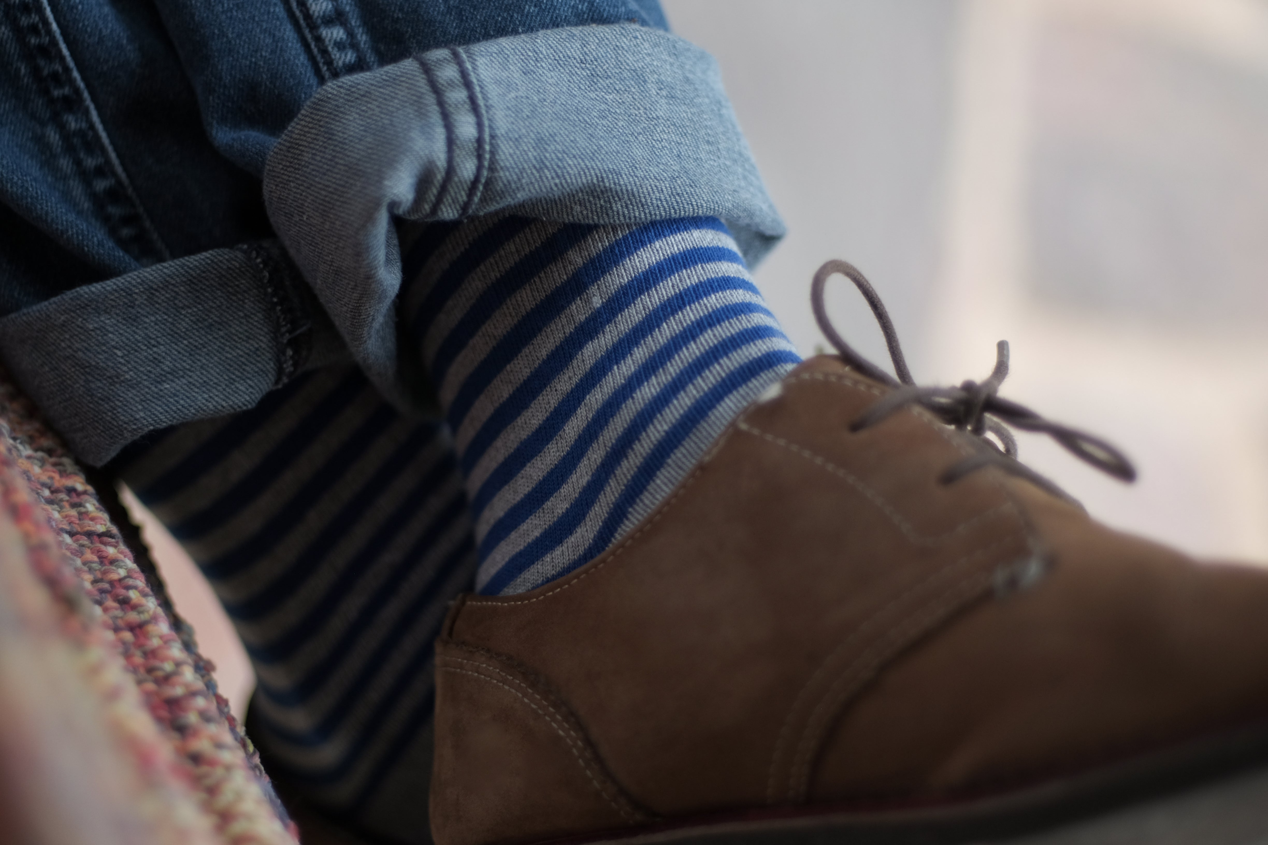 light grey and blue striped over the calf dress socks, leather brown dress shoes, blue jeans