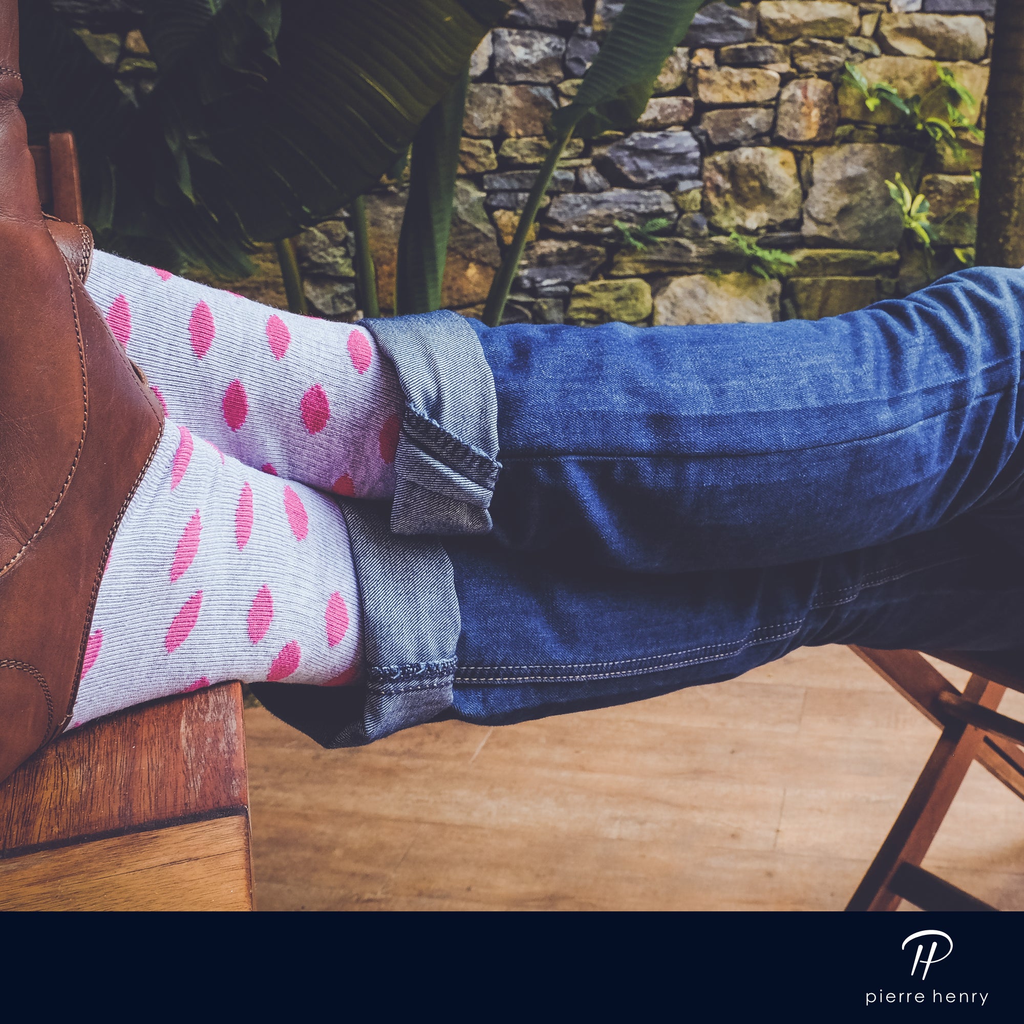 light grey over the calf dress socks with pink polka dots, brown dress shoes, legs crossed, blue jeans