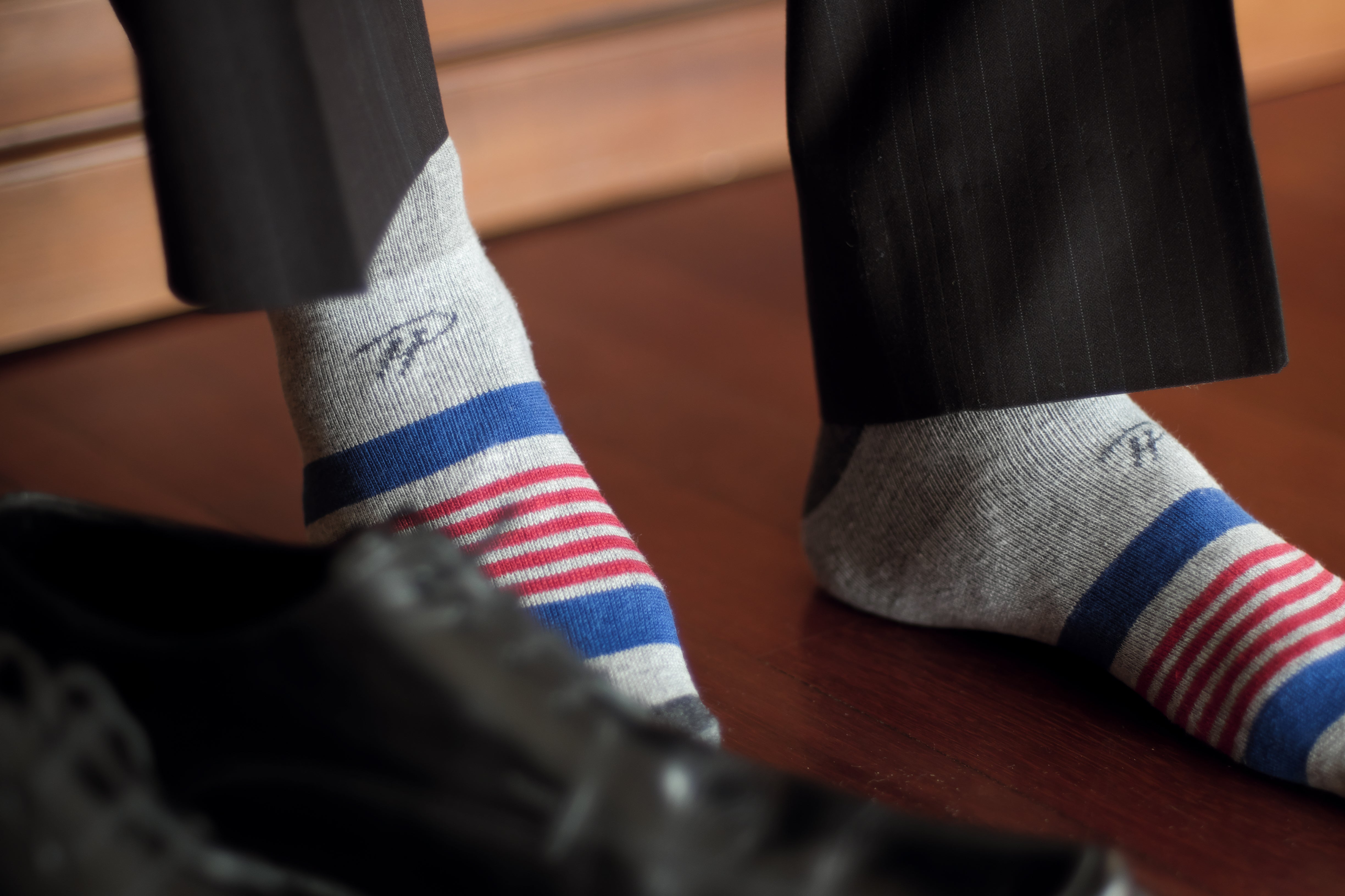 light grey over the calf dress socks with blue and red stripes, black dress pants