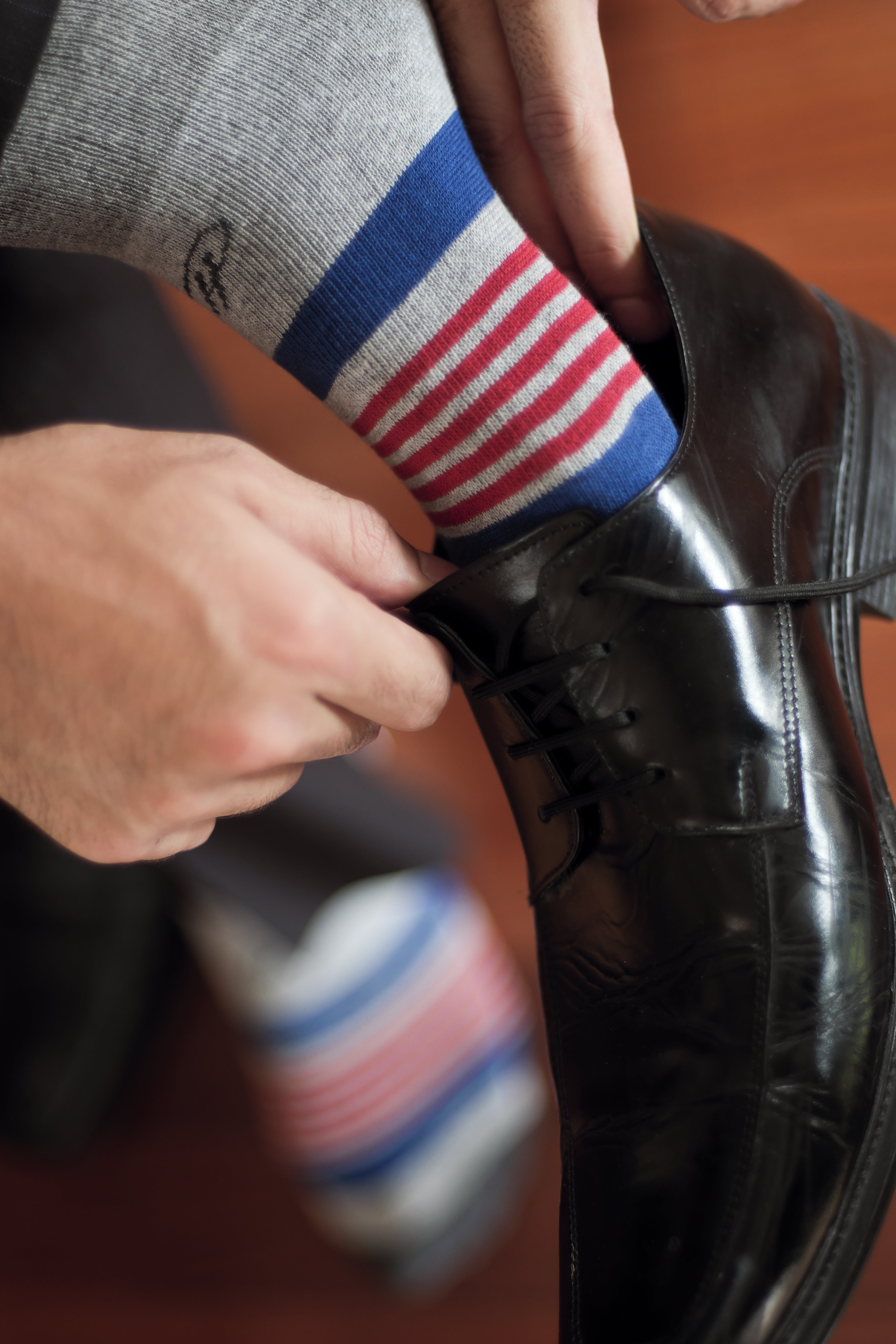 light grey over the calf dress socks with blue and red stripes, black dress shoes