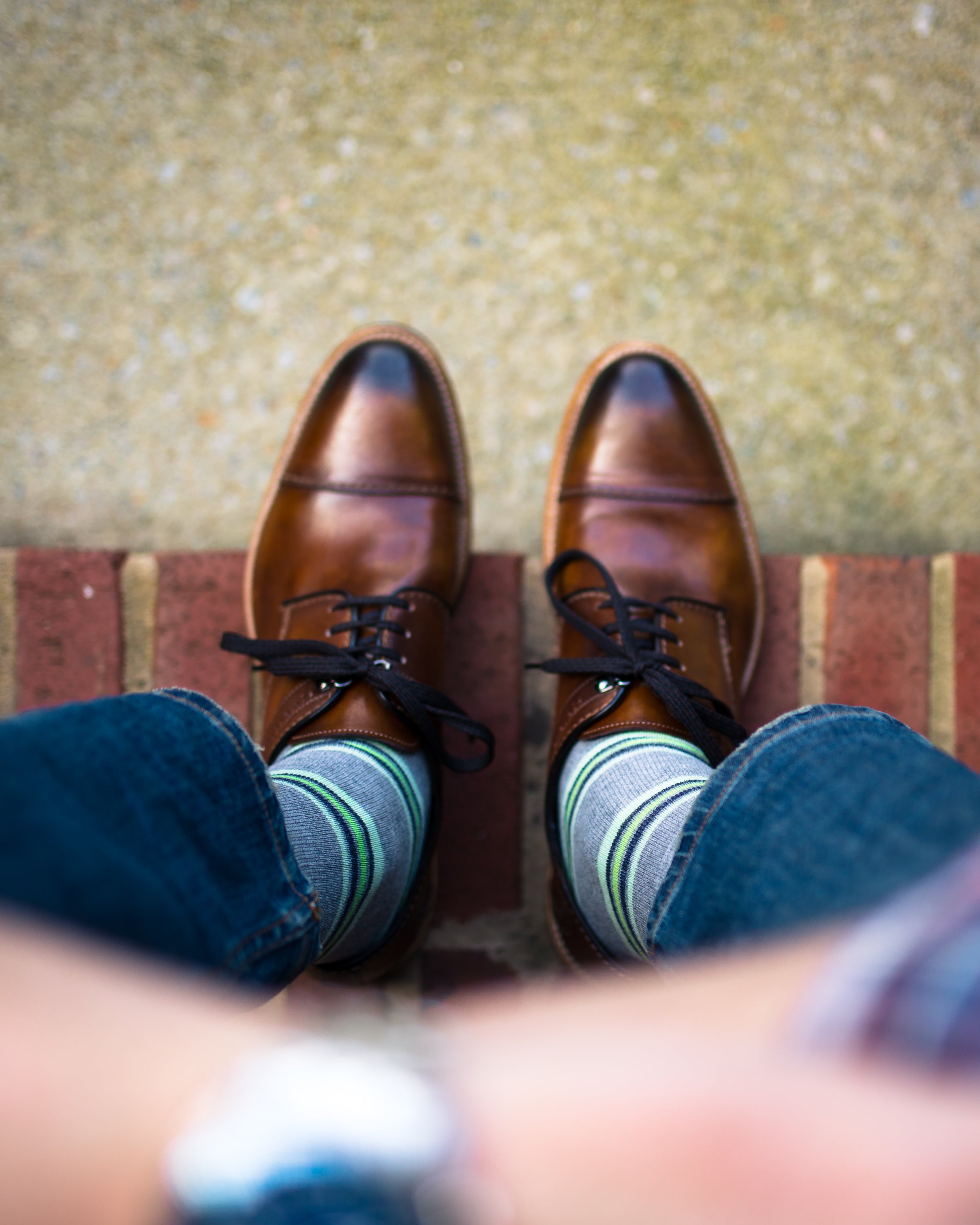 light grey over the calf dress socks with lime green stripes, brown dress shoes, blue jeans