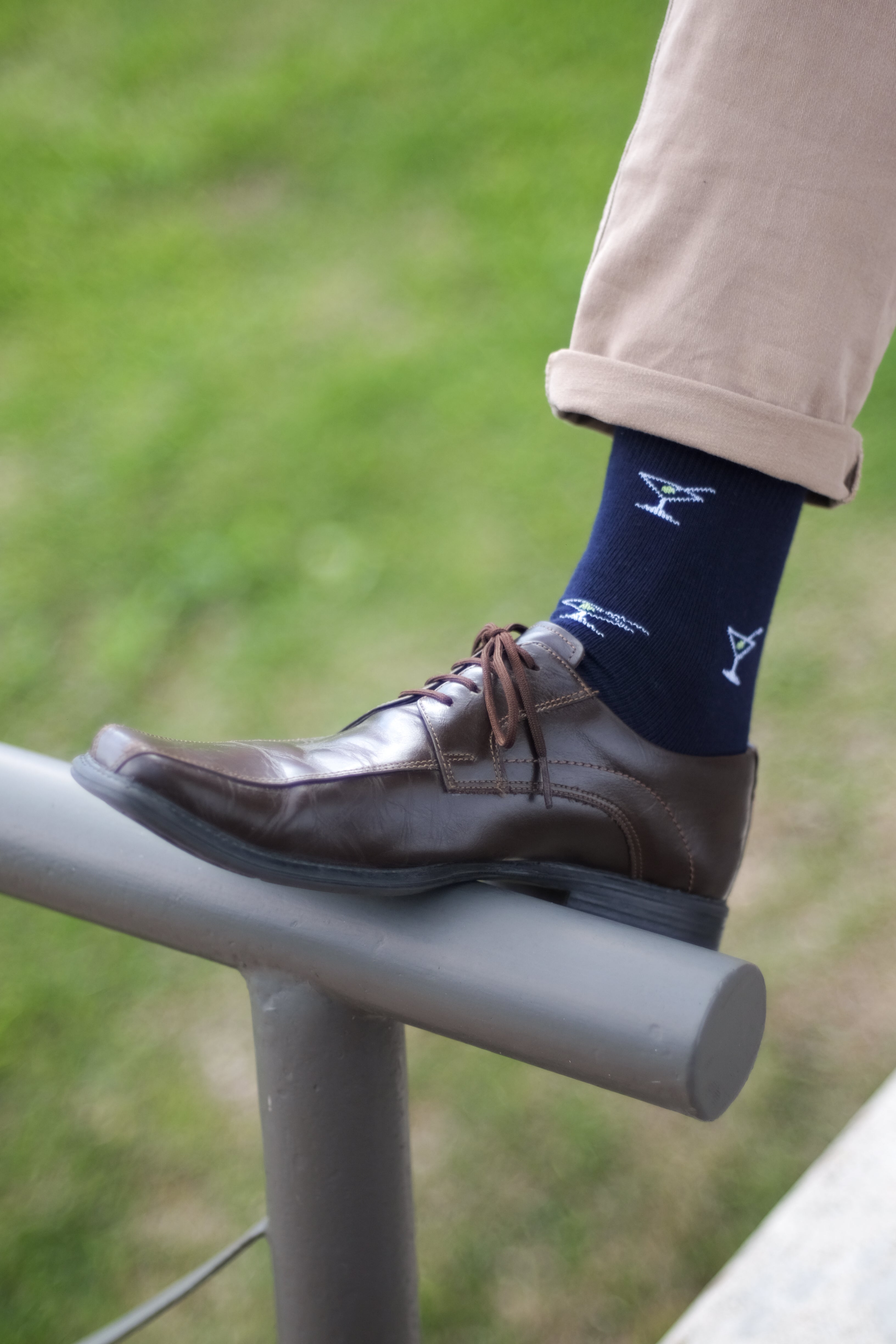 navy over the calf dress socks with cocktail pattern, brown shoes, and beige pants