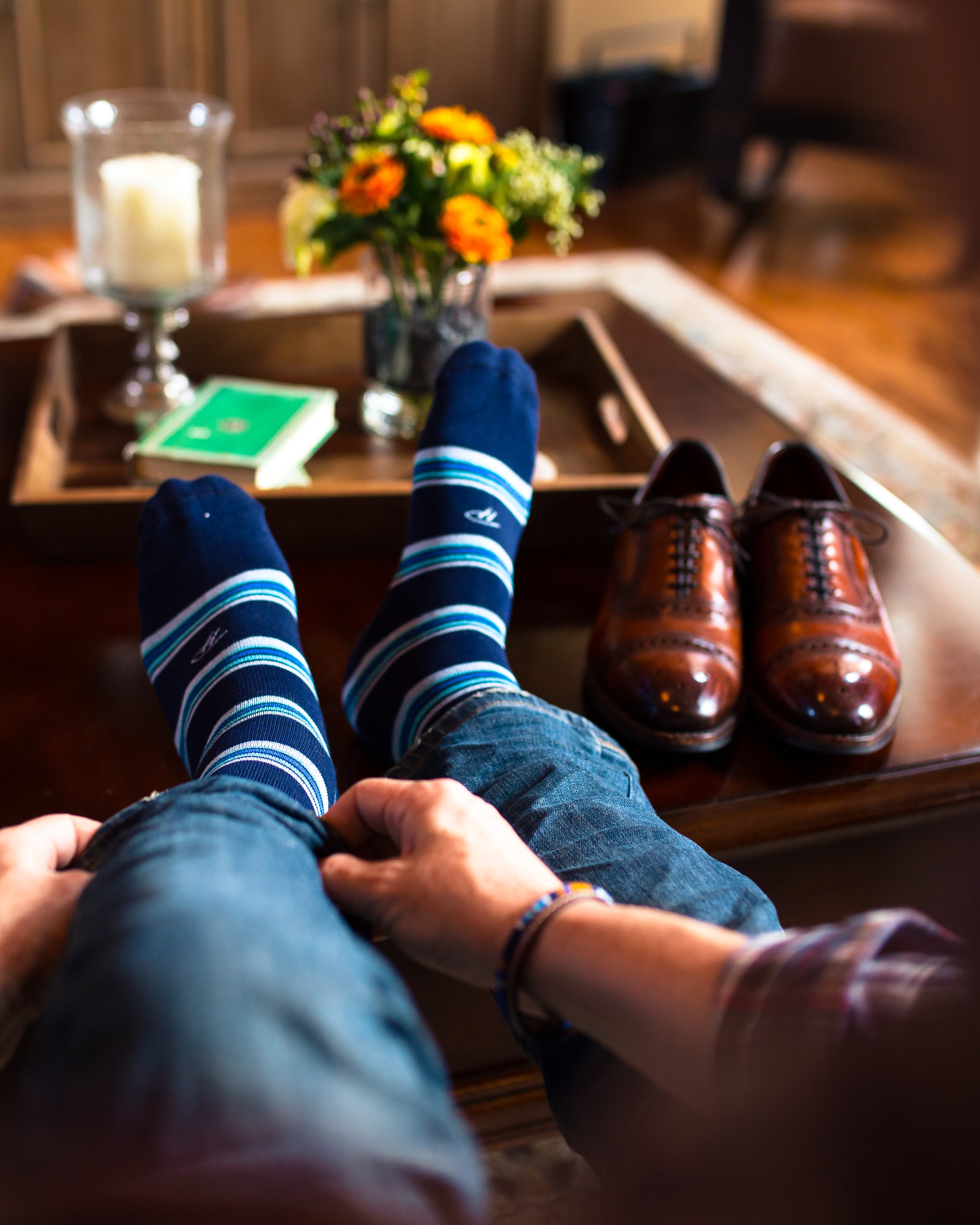 navy blue dress socks with light blue and blue stripes, brown dress shoes on table