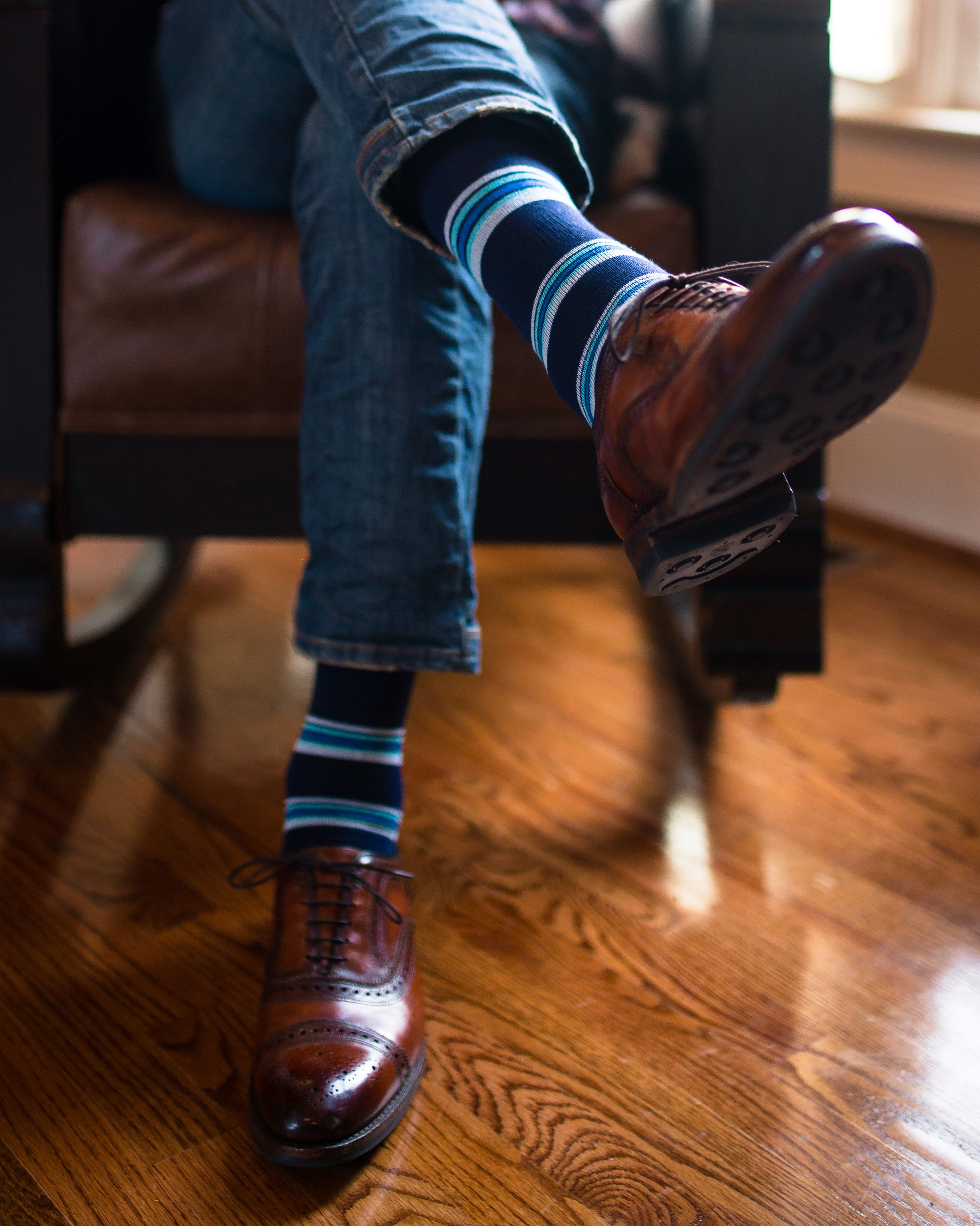 navy blue over the calf dress socks with light blue light pink and blue stripes, blue jeans, brown dress shoes