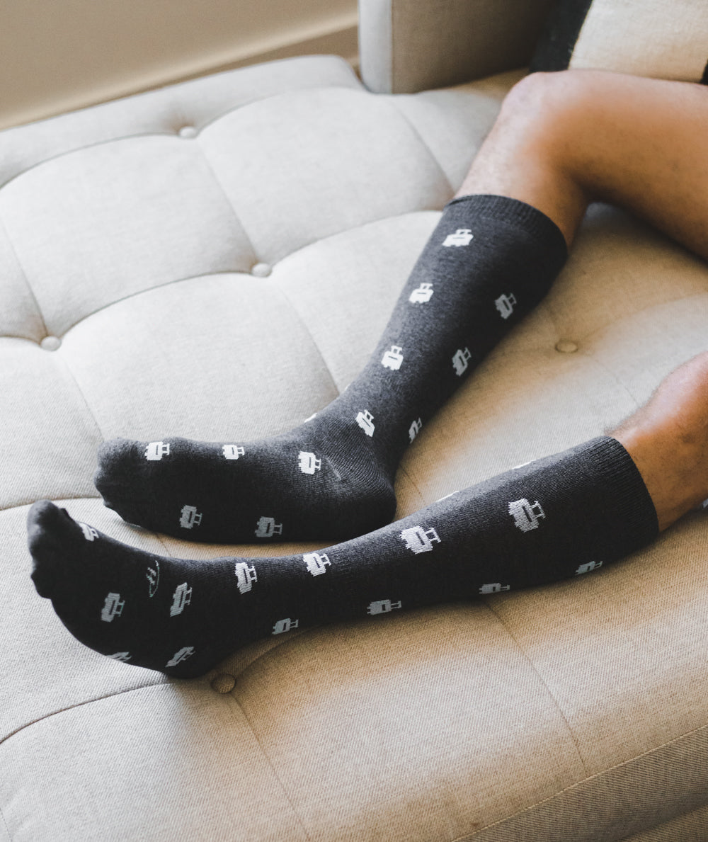 black over the calf dress socks with white print of suitcases