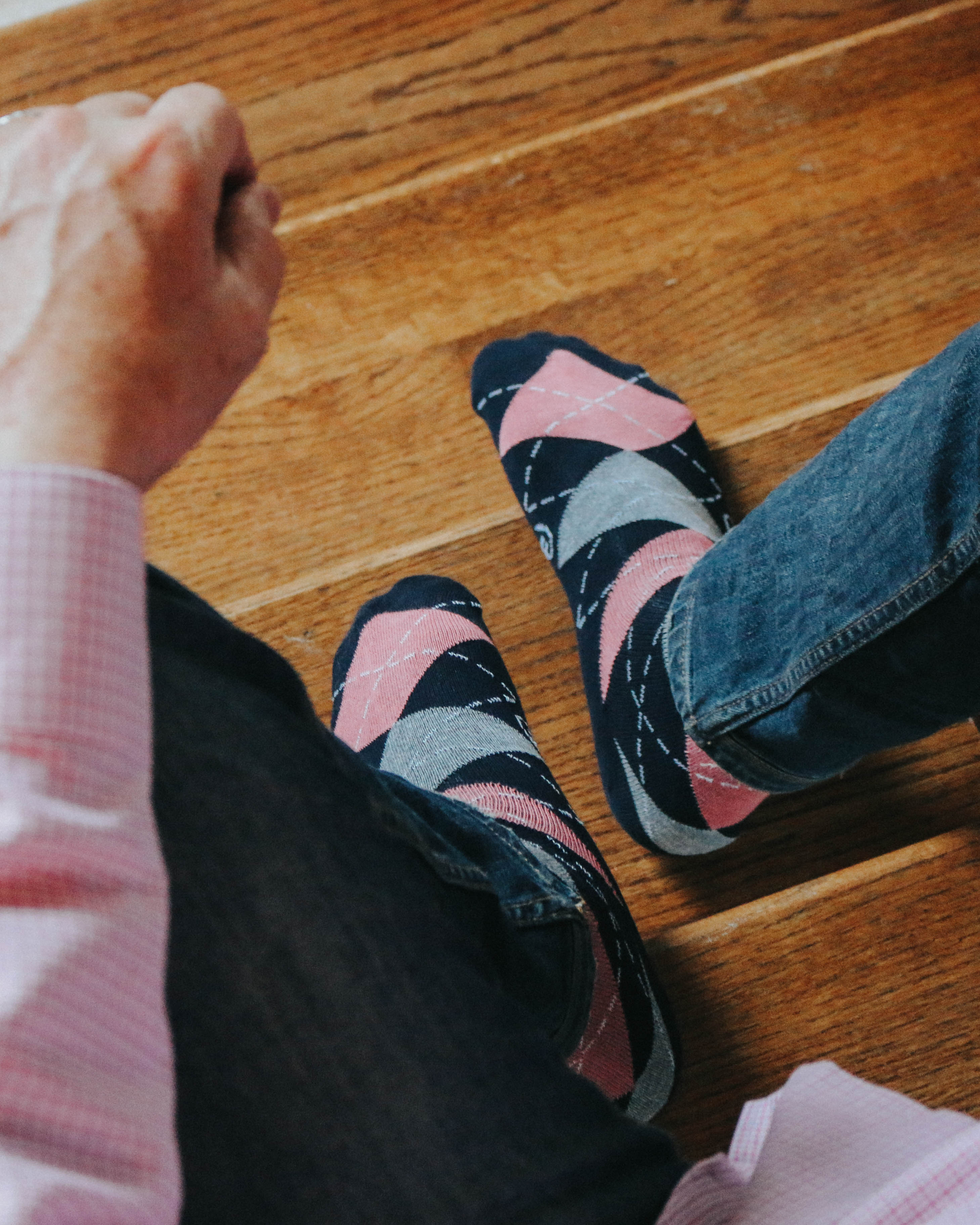 navy blue pink and grey argyle print over the calf dress socks, blue jeans, pink plaid shirt