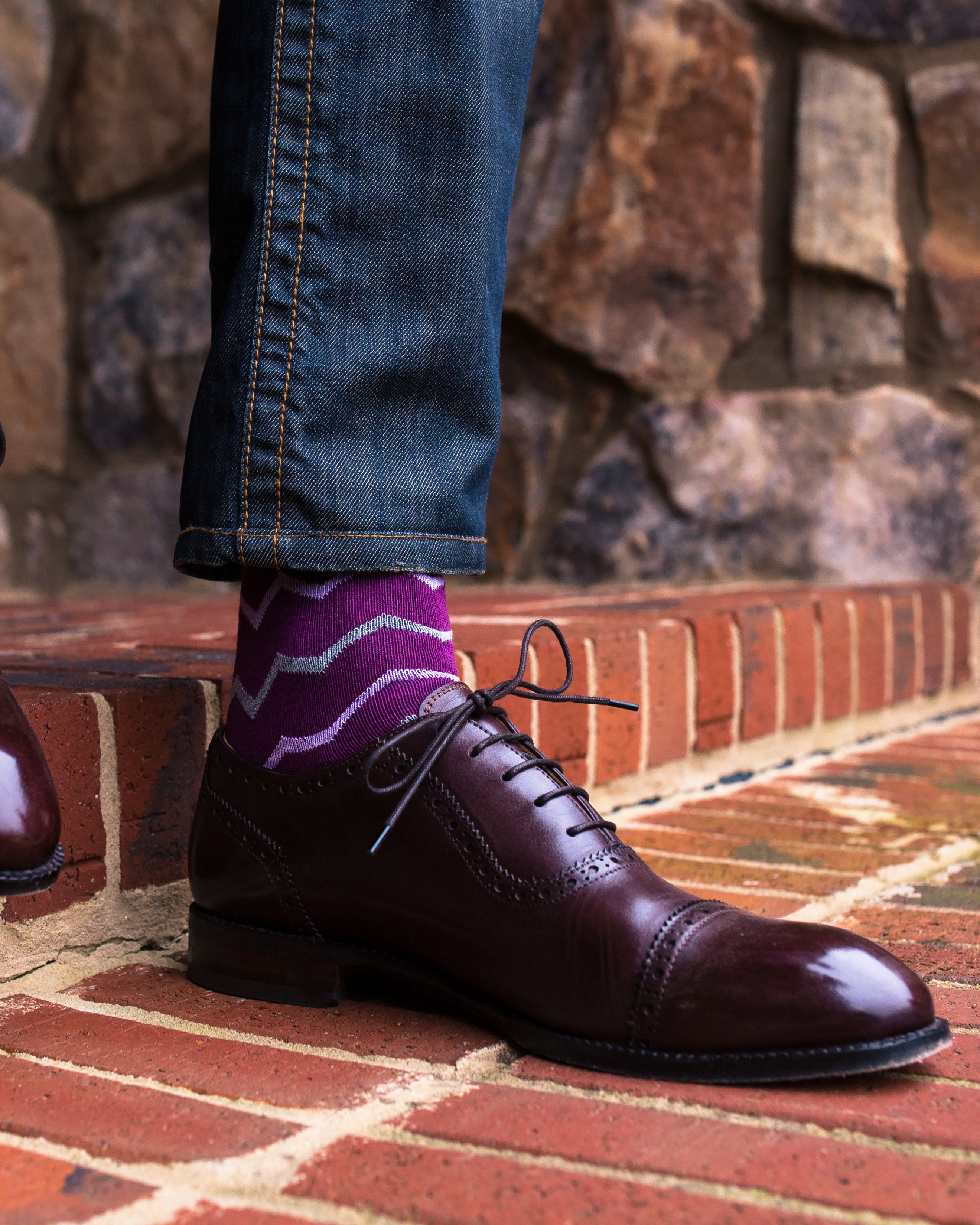 purple over the calf dress socks with light blue stripes, dark brown dress shoes, blue jeans