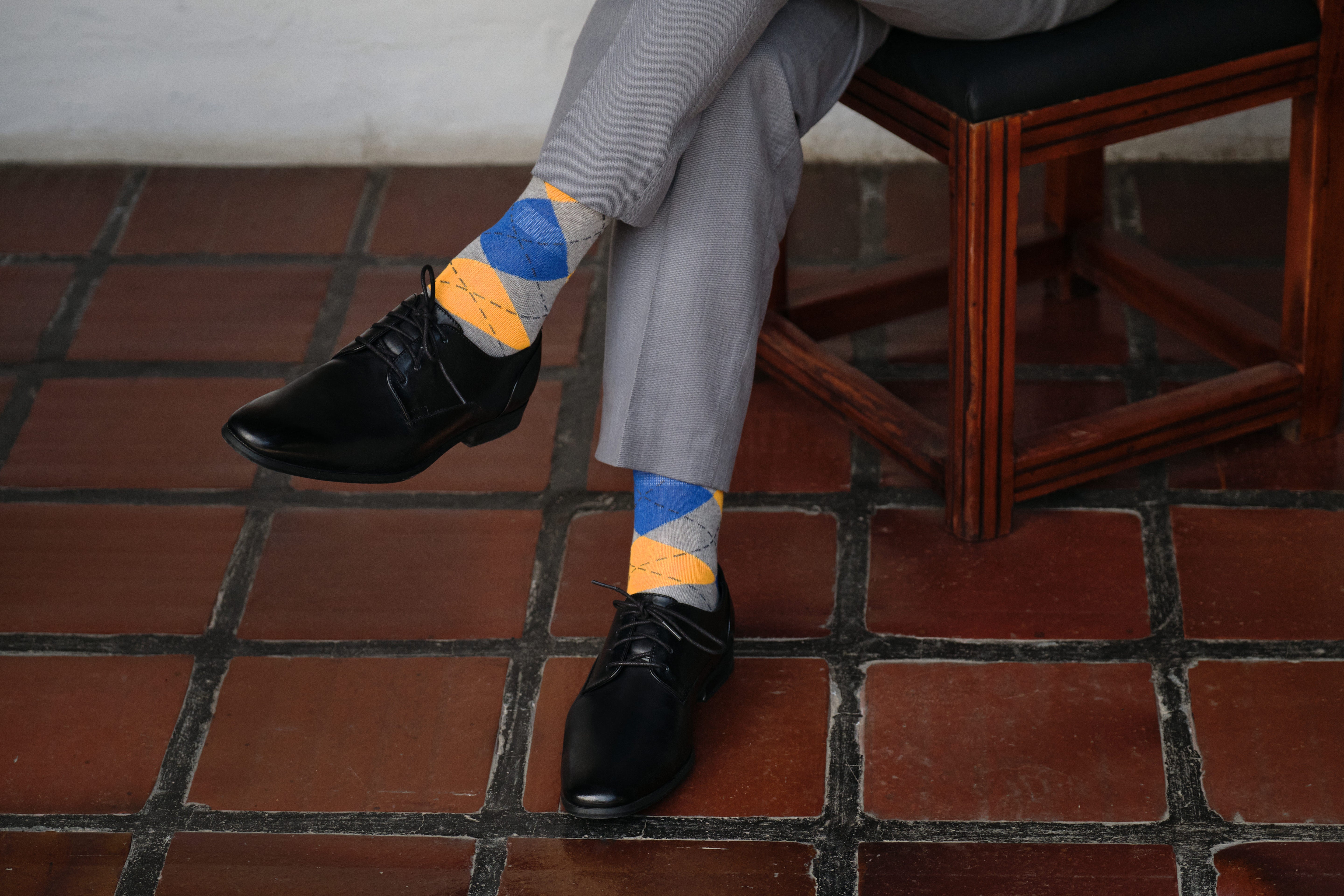 argyle grey blue and orange mid calf dress socks, black dress shoes, grey dress pants