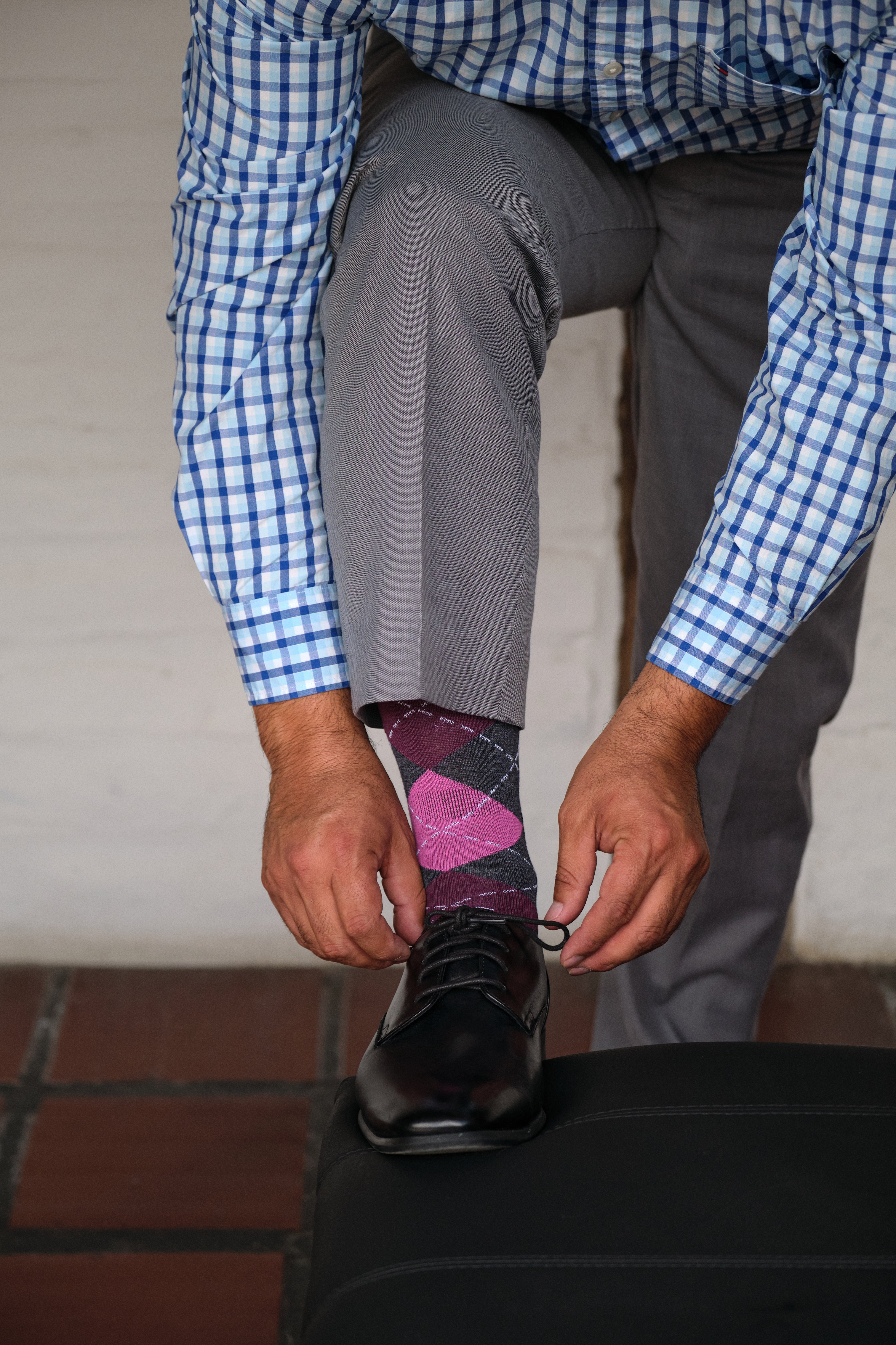 argyle pink grey and burgundy mid calf dress socks, black dress shoes, grey dress pants, plaid dress shirt