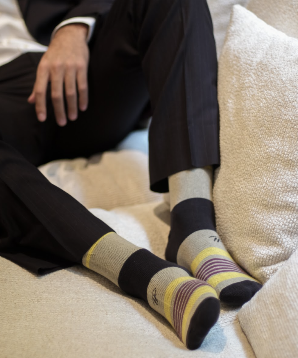 beige over the calf dress socks with black toe dark red and yellow stripes with black around the ankle and heel