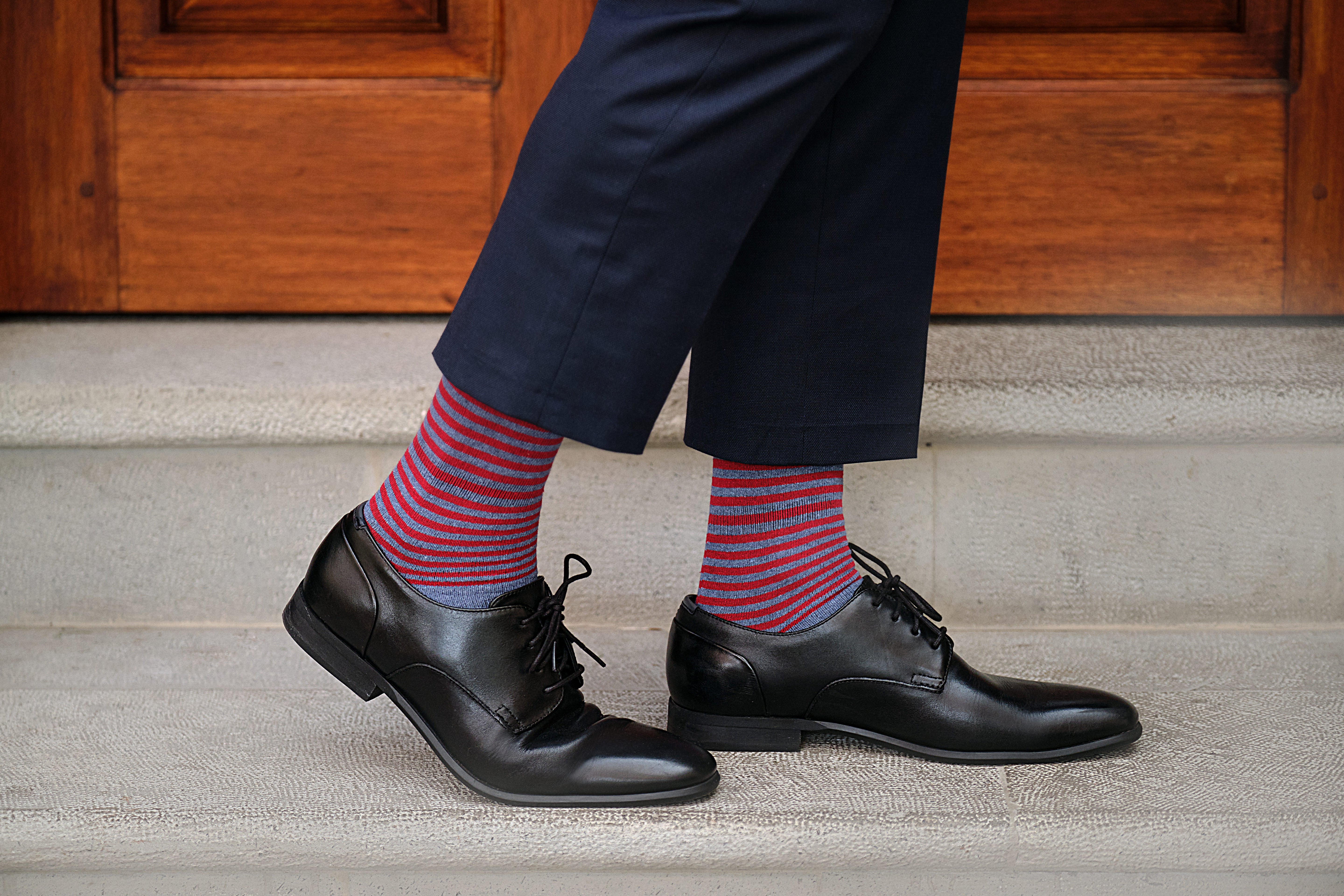light blue mid calf dress socks with red stripes, navy dress pants, black dress shoes