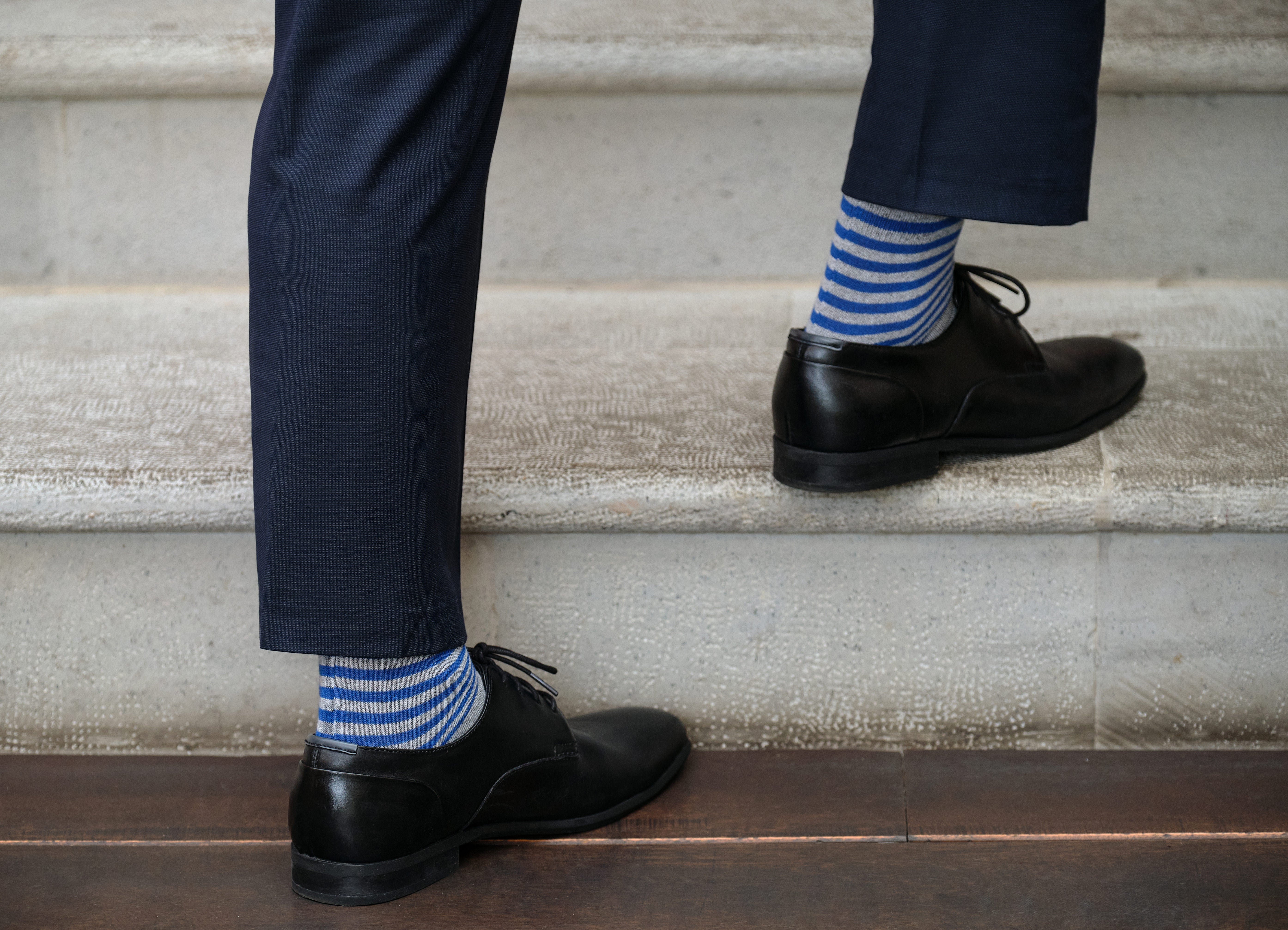 light grey mid calf dress socks with blue stripes, navy dress pants, black dress shoes