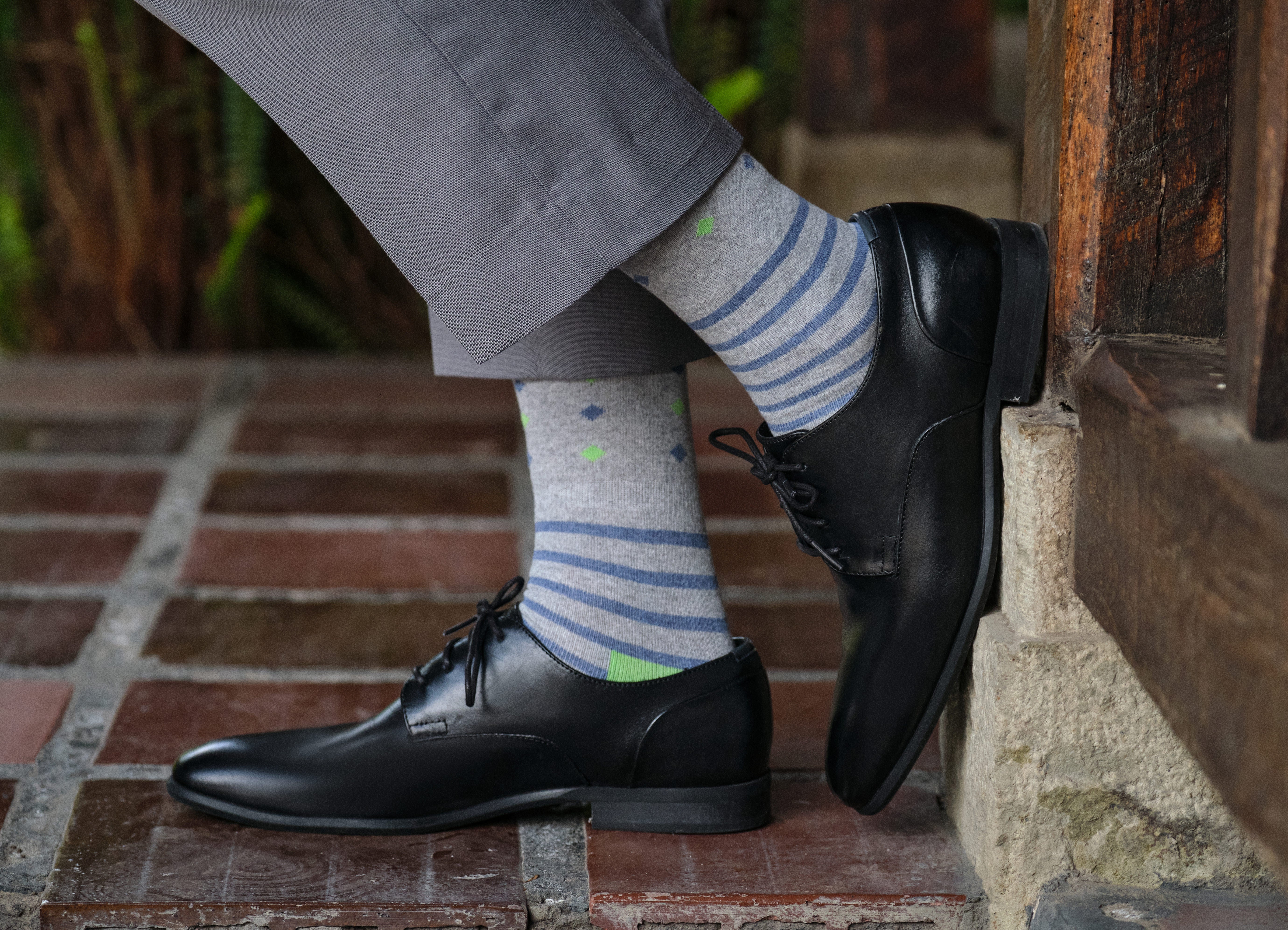 light grey mid calf dress socks with blue stripes and lime heel, black dress shoes, grey dress pants