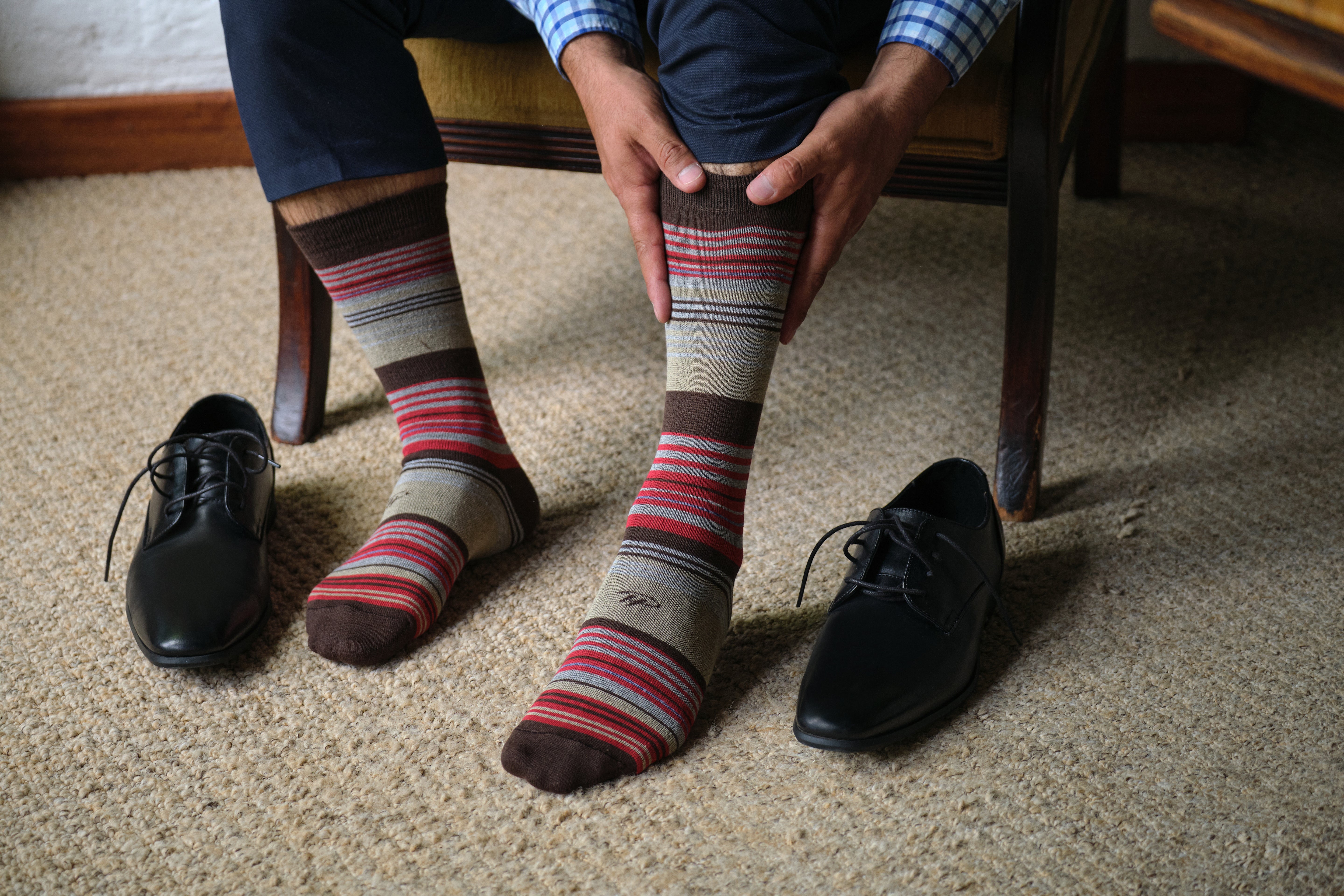 light grey mid calf dress socks with brown red and blue stripes, navy dress pants