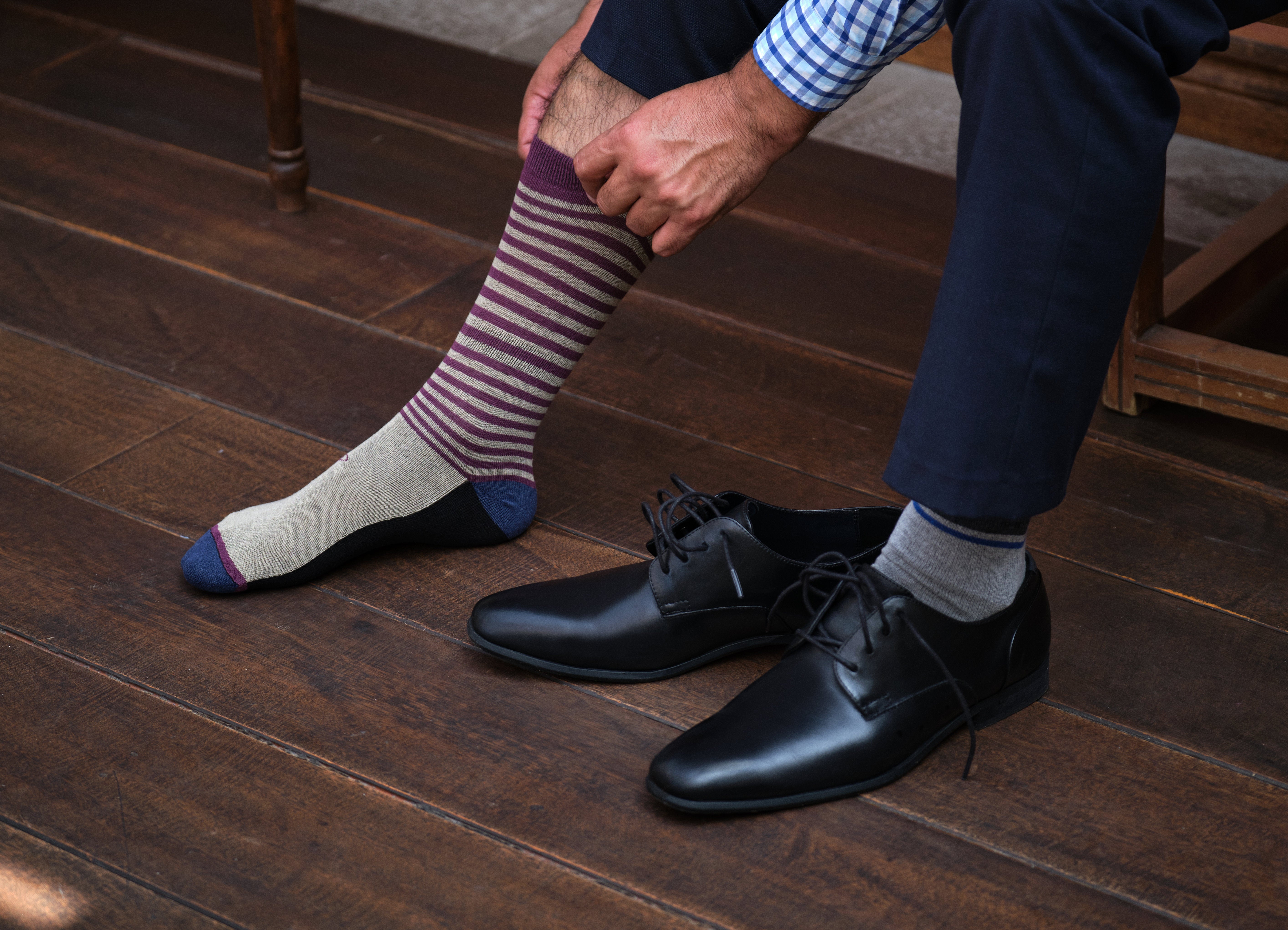 light grey mid calf dress socks with burgundy stripes, black dress shoes, navy dress pants